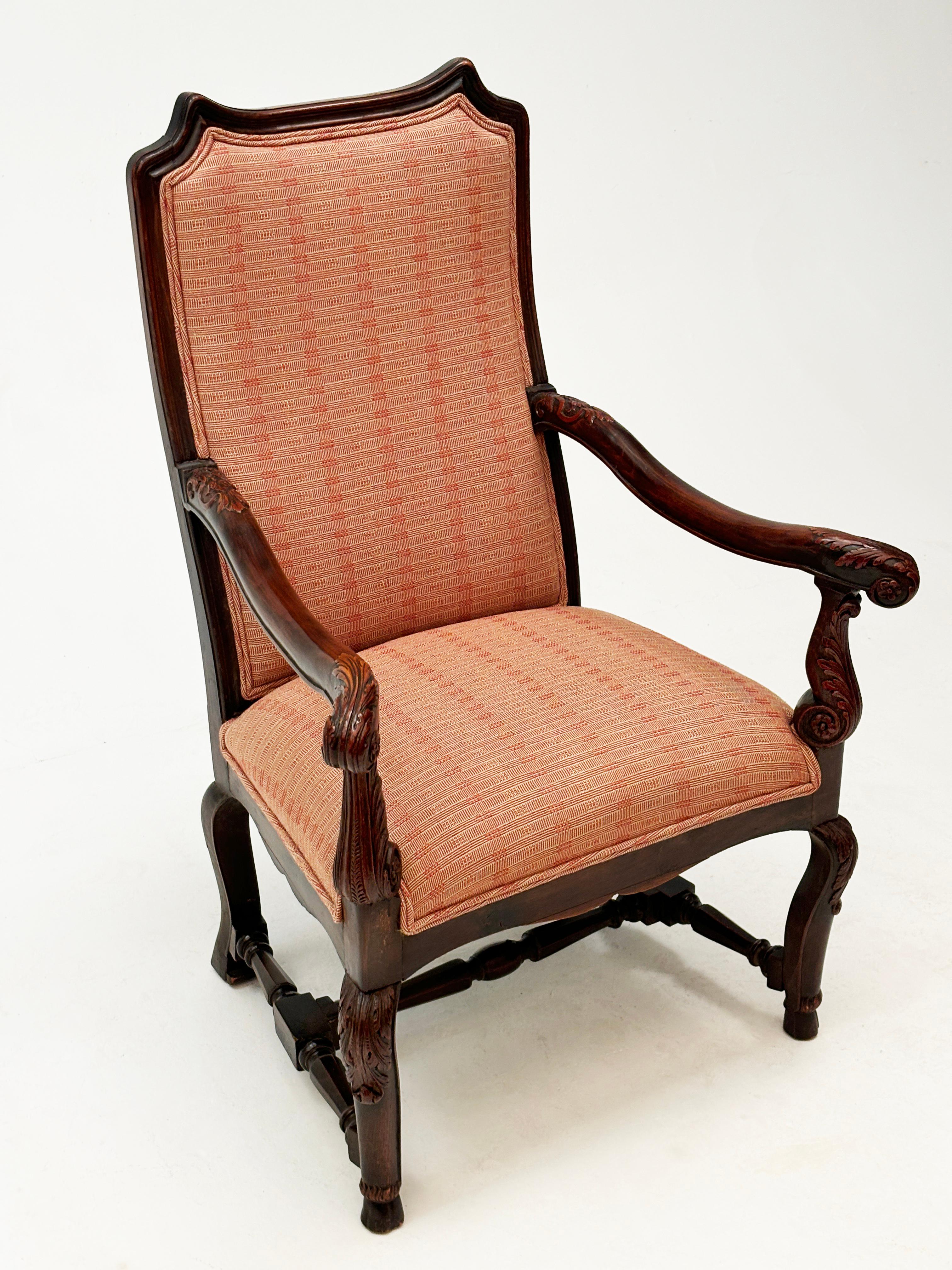 This stunning high-back French Regency chair boasts all the beautiful detail one would come to expect from this era. From the hand carved ornamentals on the arms and uprights, to the wooden framed back and hoof-like feet that terminate from a