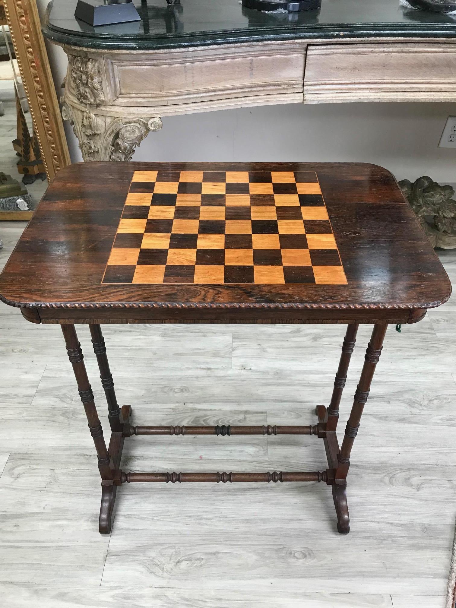 Unusual mid-1800s mixed wood game table with inlaid rosewood chess board on top and beautiful leather backgammon board in drawer.
