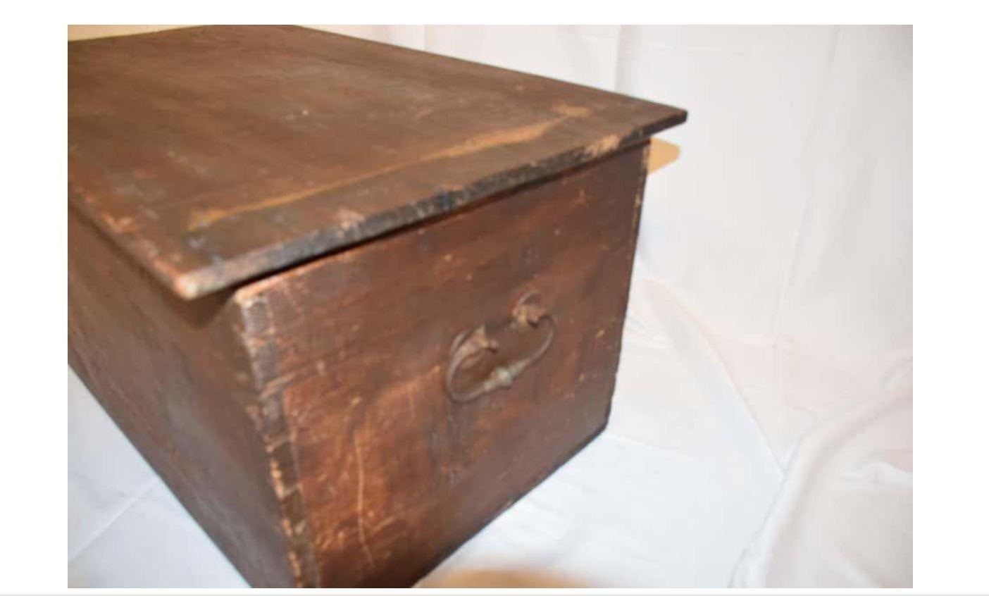 This antique rustic wooden trunk features hand forged handles and hinges with a hand carved interior and dovetailed corners. Today this trunk would make a great feature in a stylish living room, bedroom or study.

H 18.25 in. x W 36.25 in. x D