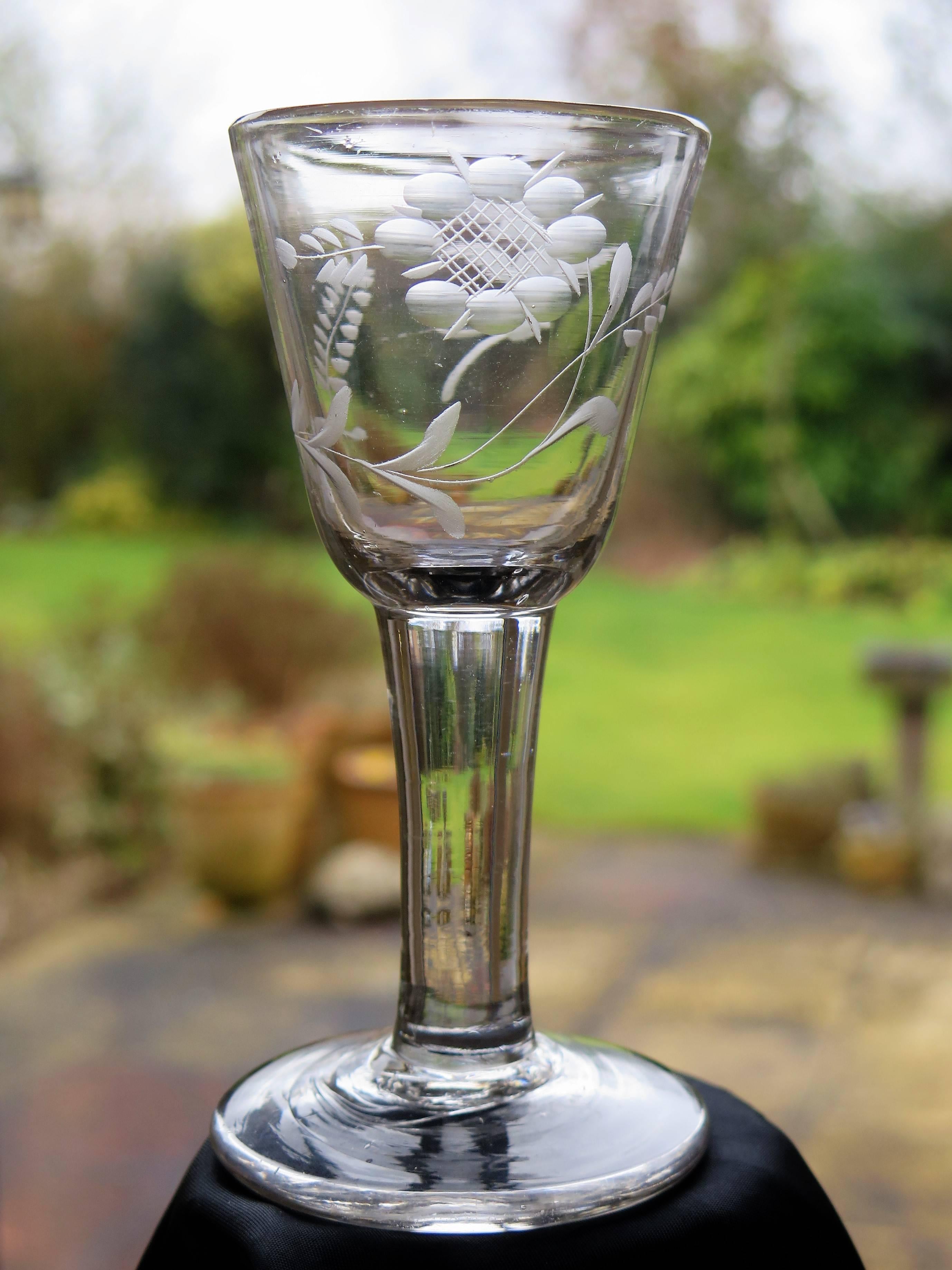 This is a good handblown, English Jacobite, mid-Georgian, wine drinking glass with an engraved bowl, dating from the middle of the 18th century, circa 1750.

Jacobite glasses have historical significance and are very collectable.

This glass is made