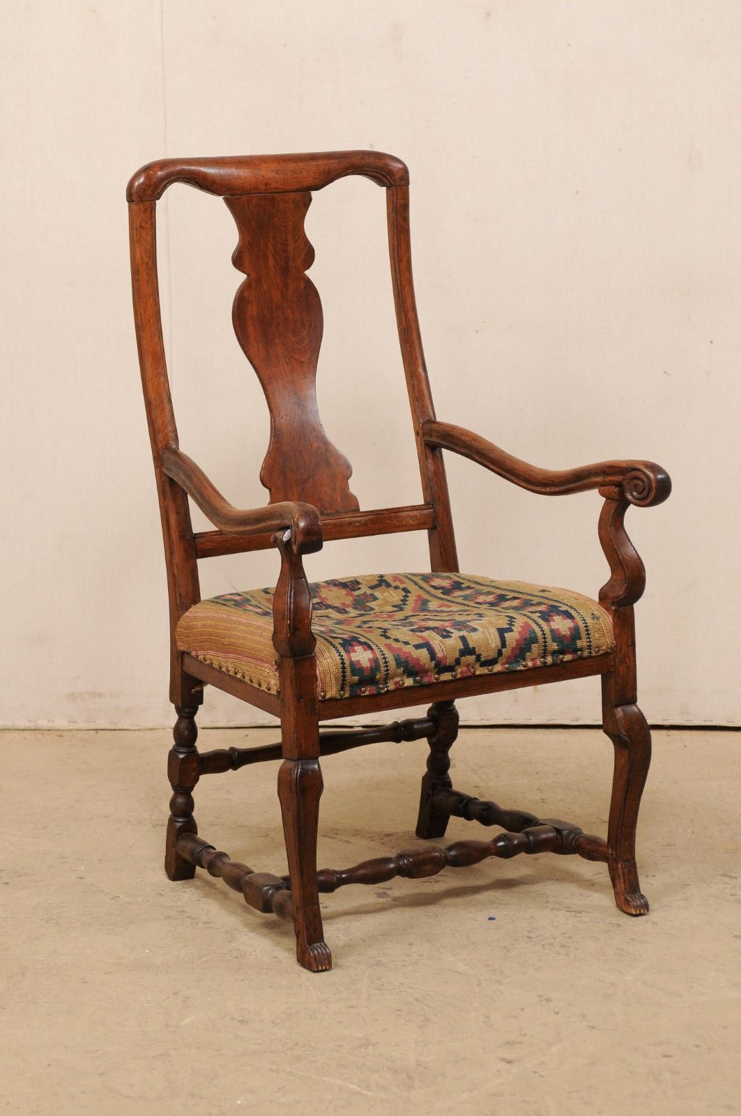A Swedish carved-wood single arm chair with fabulous old woven fabric upholstery from the mid-18th century. This antique chair from Sweden, though period Rococo, is more subdued in it's carvings, more likely from the country than city. It is quite a