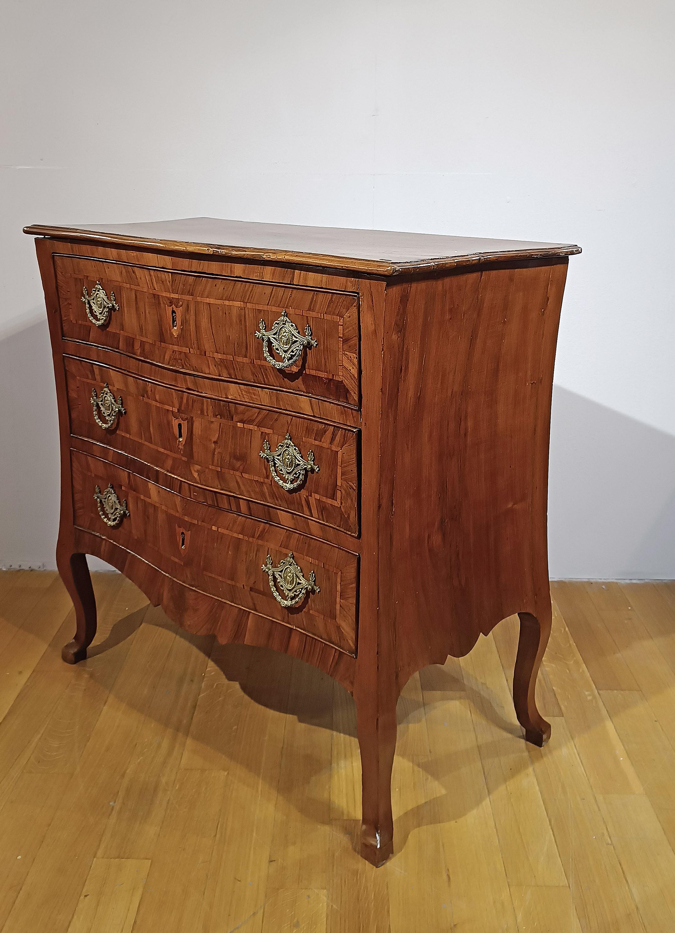 Elegant leaf-shaped chest of drawers in solid walnut and veneer. The chest of drawers features a curved profile and curved legs, lending a touch of refinement. The front features three ergonomic drawers, ideal for storing objects, decorated with