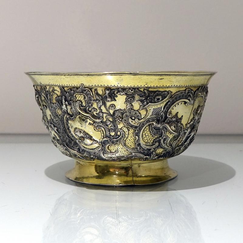 A stunning 18th century silver-gilt bowl decorated with exceptional quality floral, grape and vine hand chasing which is then entwined around specks of lattice work engraving to create a majestic design. 

Weight: 8.3 troy ounces/260