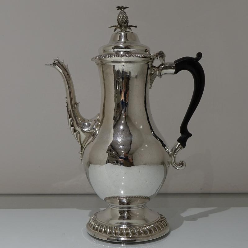 A beautiful pear shaped coffee pot decorated with elegant gadrooned moldings around the lid and foot. The domed lid is hinged and is crowned with an ornate finial.

Weight: 30 troy ounces/935 grams

  

   