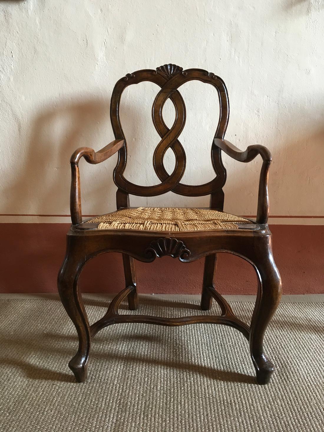 Mid-18th Century  baroque hand-carved 1750 Venetian walnut armchair.
Straw seat not original.
The 18th Century was in Venice the Golden Age and this armchair is a remarkable work by Venetian cabinetmakers. The carvings' refinement enhance its