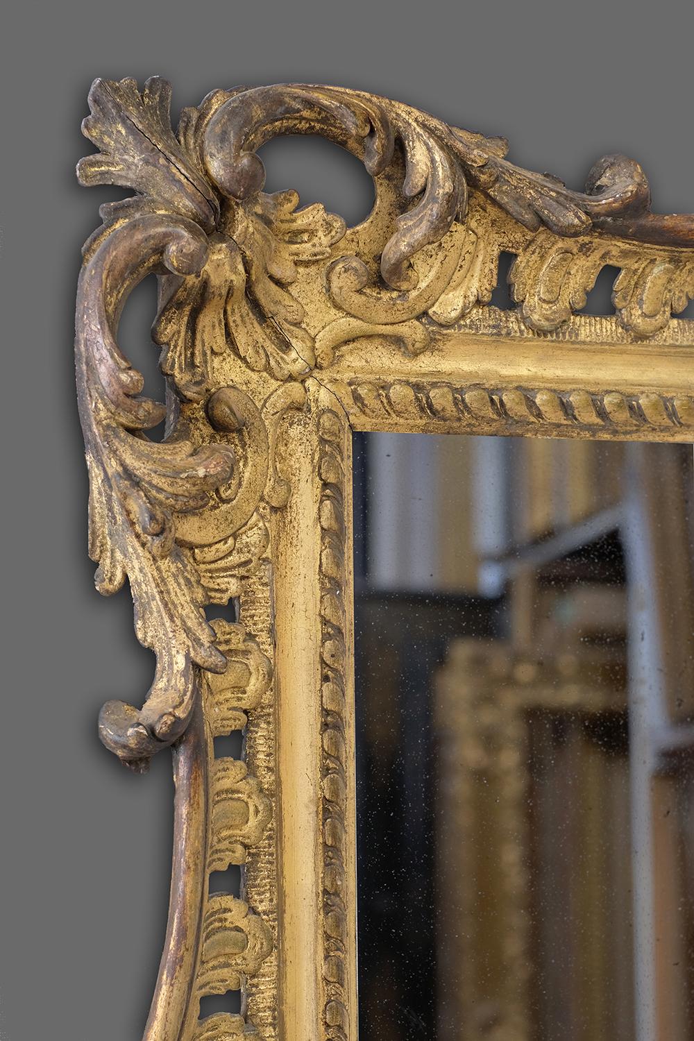 This is a very fine mid-18th century hand carved British Rococo frame, with pierced foliate-scrolled corner-&-centre cartouches linked by openwork rocaille panels with swept rails; gadrooned sight; all re-cut in the gesso. The frames original oil