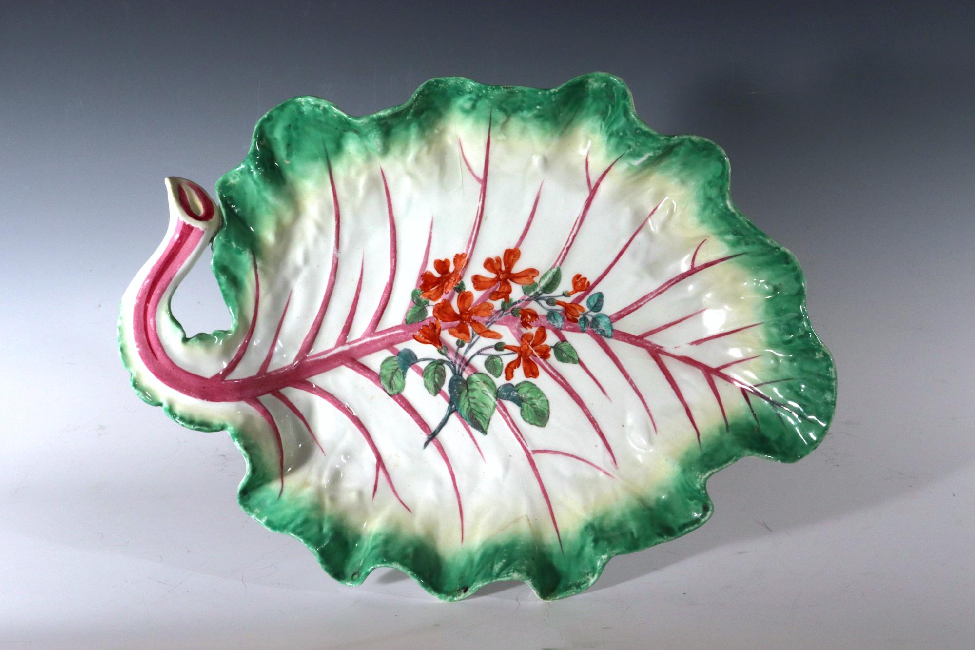 Chelsea Porcelain Botanical Dish,
Brown Anchor Period
circa 1758-60

The large red anchor period Chelsea Porcelain tromp l'oeil leaf dish is naturally colored and modelled as an open cabbage leaf with a curved stem issuing puce moulded veins,