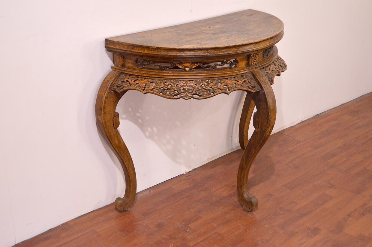 This half-moon table has a more elaborate curve to the legs, referred to as the cabriole leg. This leg style is often seen in European furniture and is often attributed to the information exchanged throughout the Silk Road. This table comes from the