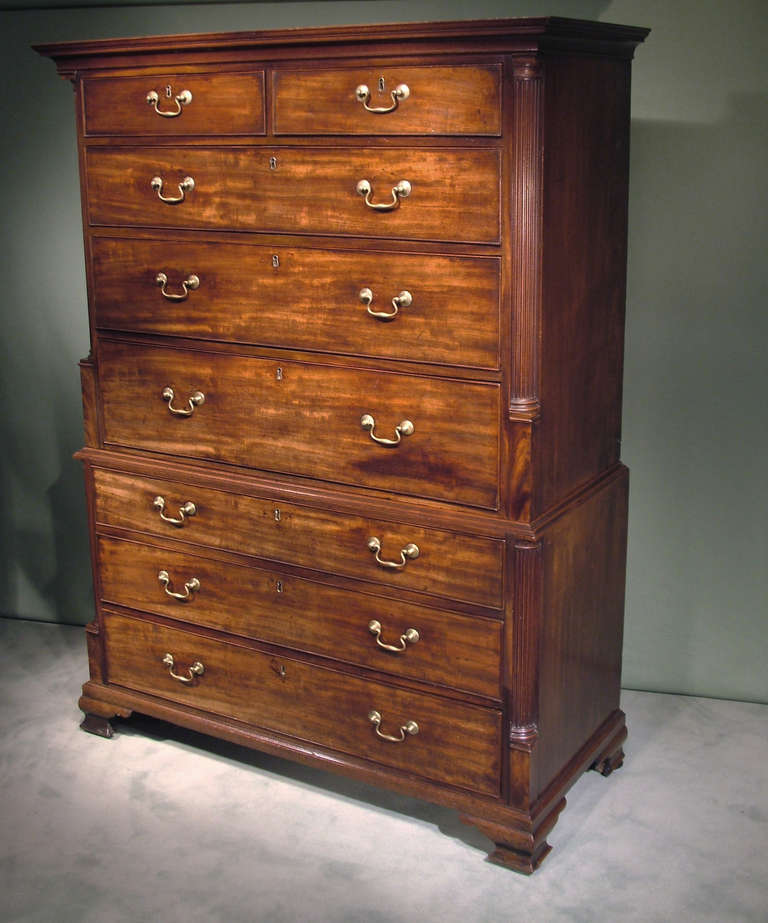 A mid-18th century Chippendale period well-figured mahogany tallboy of attractive small proportions with graduated drawers, flanked by fluted corner columns to top and base, supported on ogee bracket feet.