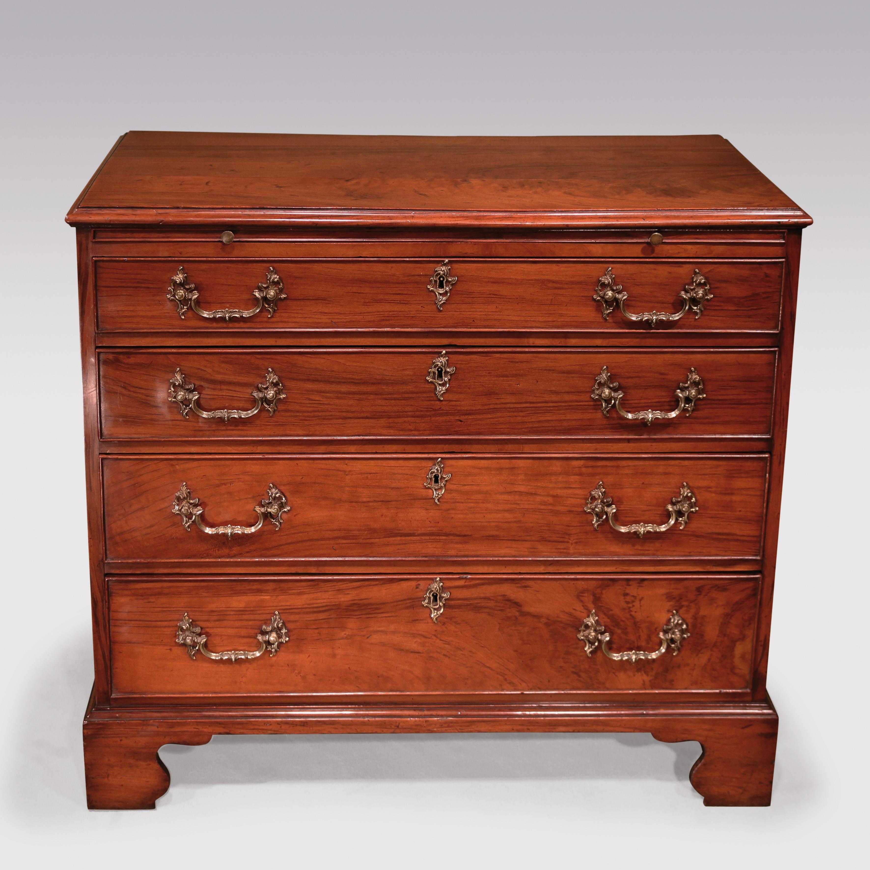 An unusual mid-18th century Chippendale period padouk wood straight front chest, above moulded edge top, having brushing slide and 4 graduated cock-beaded drawers, retaining original rococo handles, supported on shaped bracket feet.