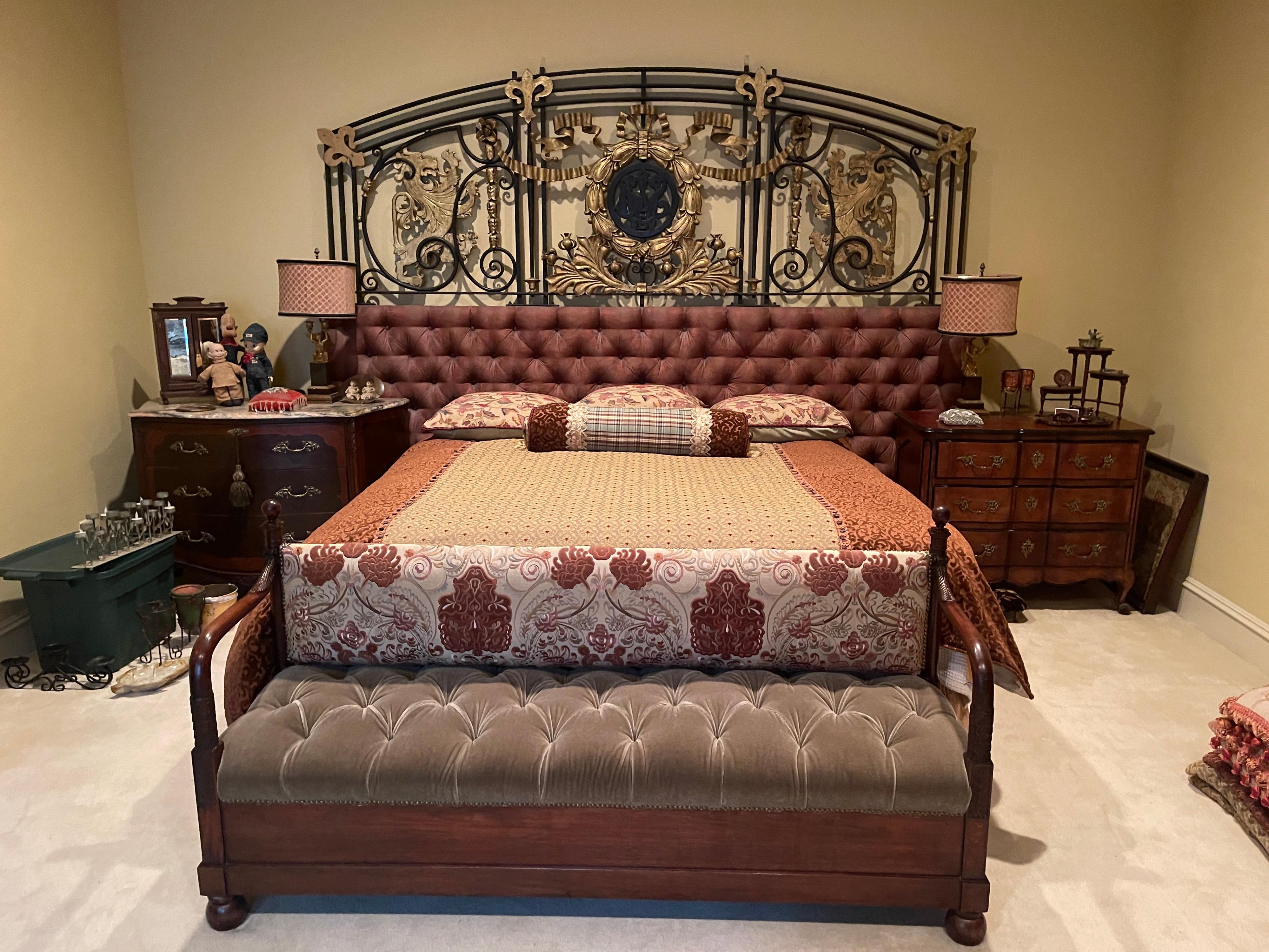 Decorate a master bedroom with this exquisite antique oversized headboard. Crafted in France circa 1780 out of a retired iron and bronze gate or balcony, the Louis XVI-style frame features two main parts; the top is arched, with bronze Fleur-de-Lys,