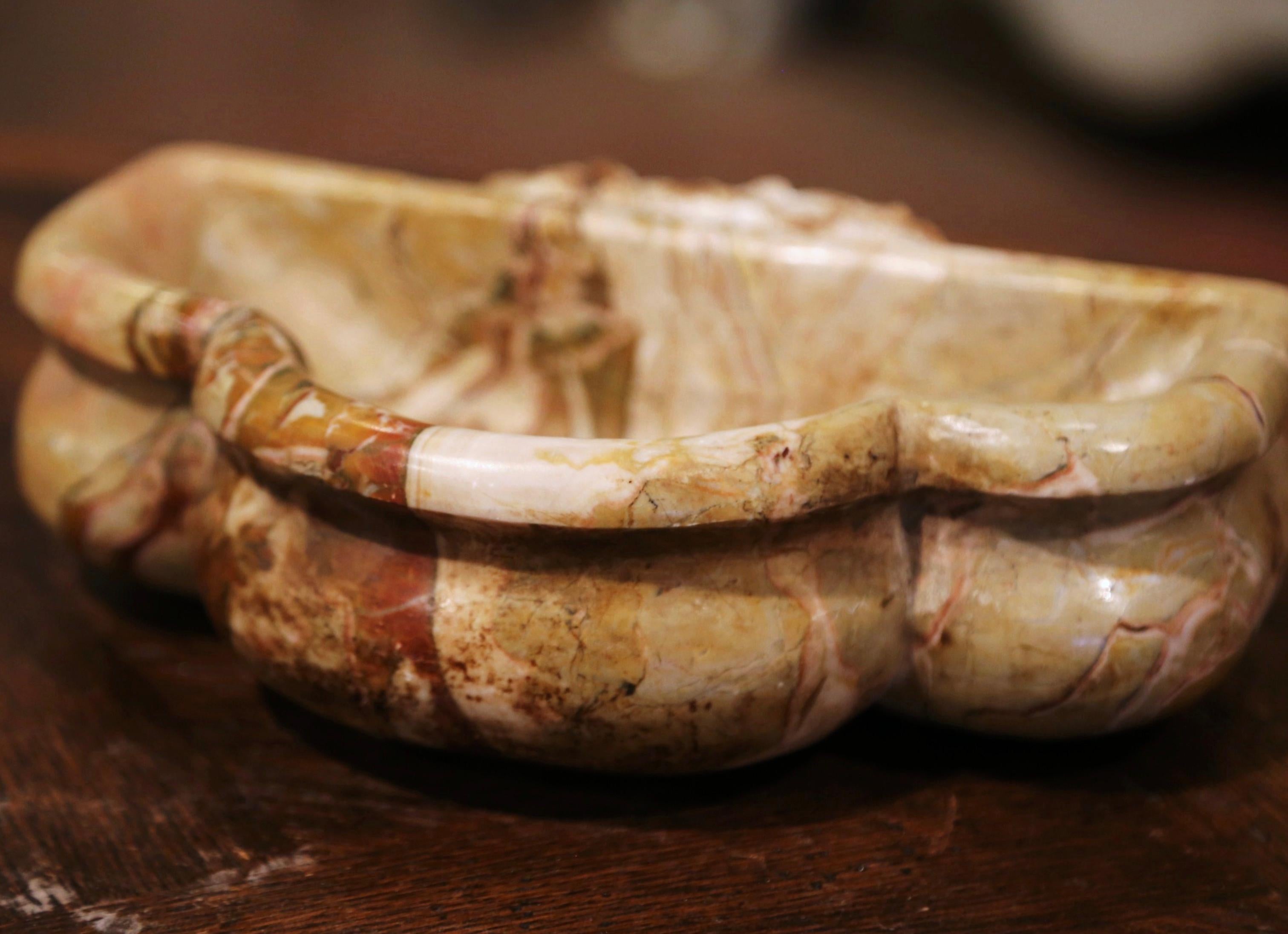 This antique dish shaped as a shell was carved in France circa 1760. Originally at the entrance door of a private chapel, this stoup was inserted in the wall and used to hold the Holy Water. The variegated beige and rust marble church recipient is