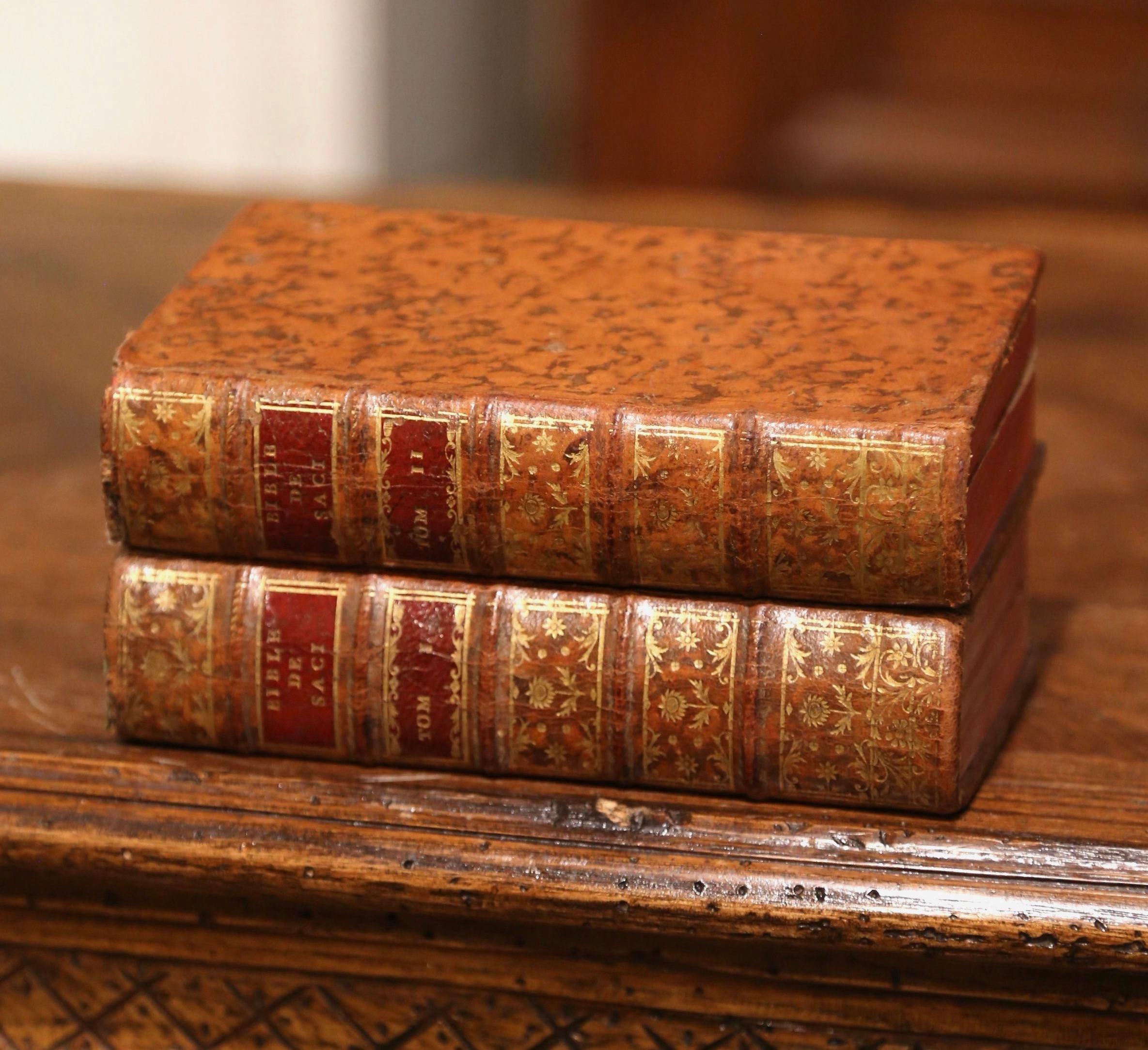 These Bible books with brown leather covers were printed in Paris, France. Dated 1743 and written in 