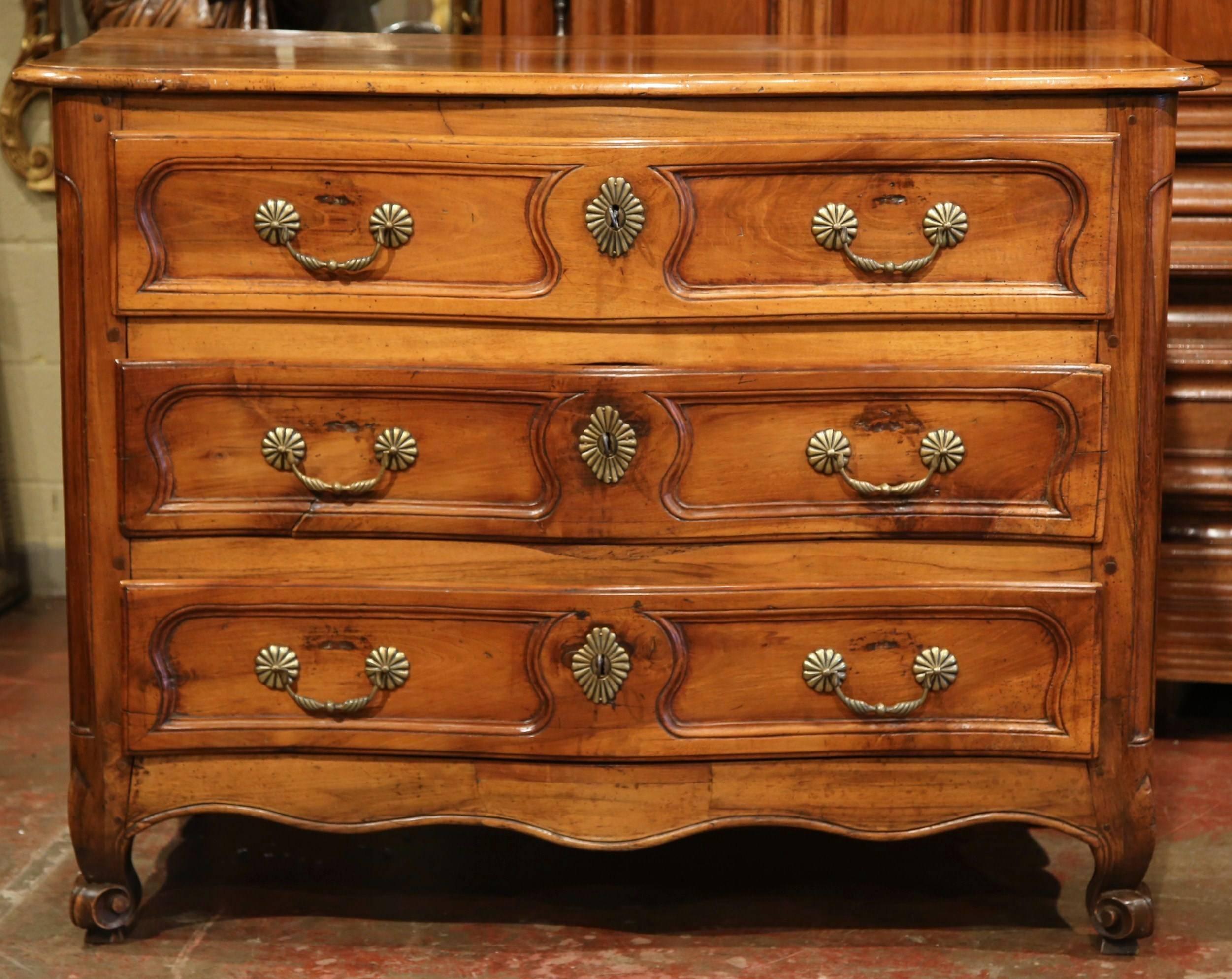 Decorate an entry, living room or bedroom with this elegant antique chest of drawers. Crafted in eastern France, circa 1760, the large fruitwood 