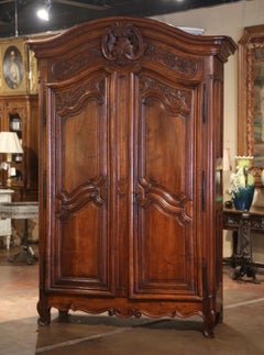 18th Century French Louis XV Carved Walnut Armoire Lyonnaise with Floral Motifs