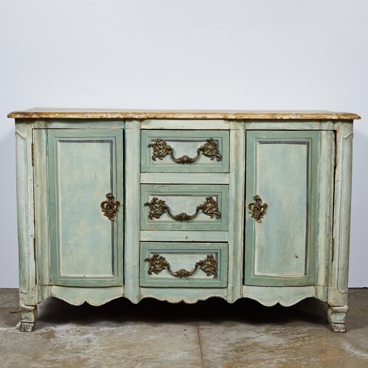 Mid 18th-century Neoclassical buffet or sideboard cabinet from the Normandy region of France. Painted beautiful shades of celadon,  the piece features a faux marble top, carved apron, bracket feet and ornate gilt hardware. With its three central