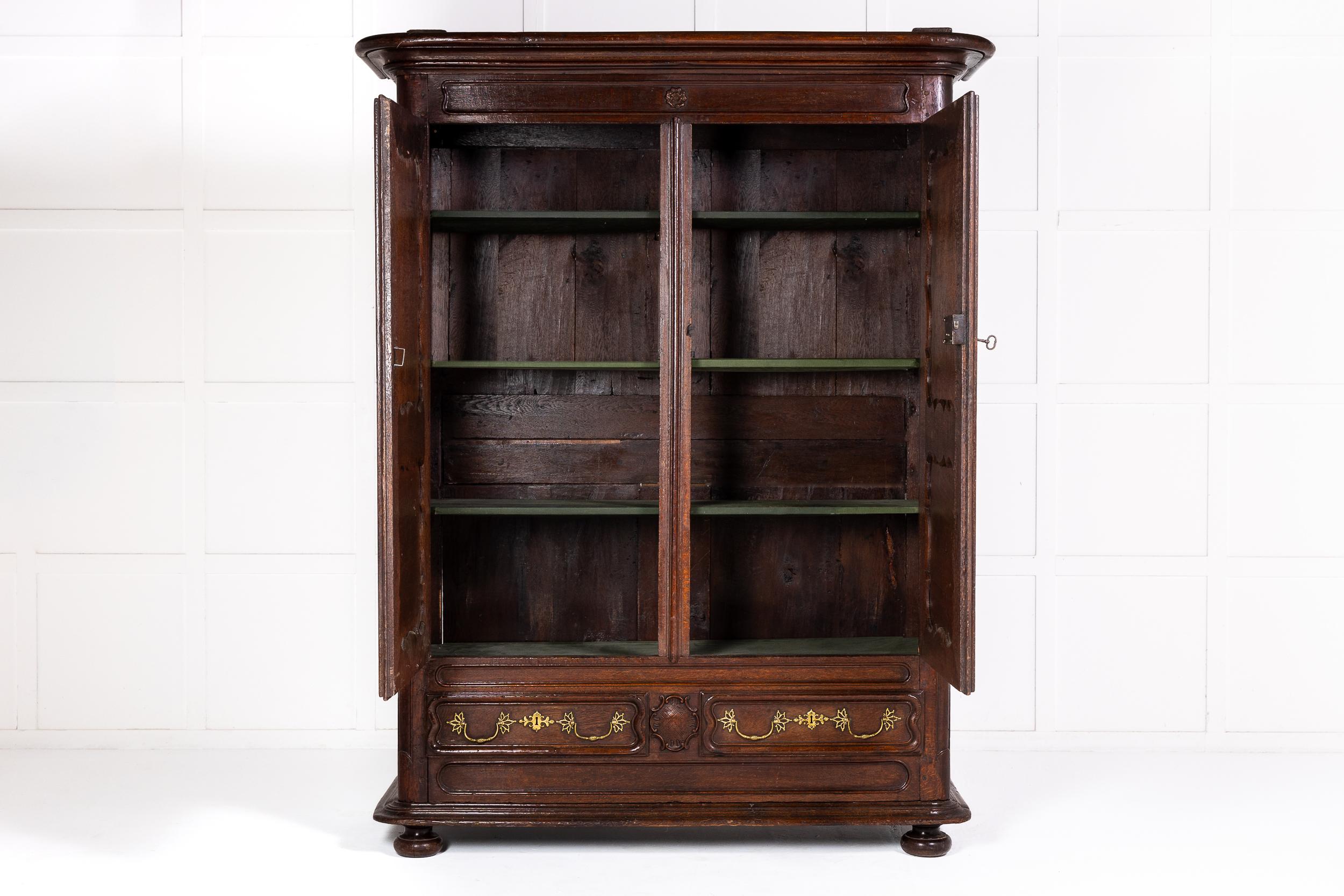 A Fine Mid 18th Century French Provincial Oak Armoire or Cupboard of Substantial Quality.

This fine armoire was made around the middle of the 18th century in France and incorporates rococo features such as the finely panelled front and,