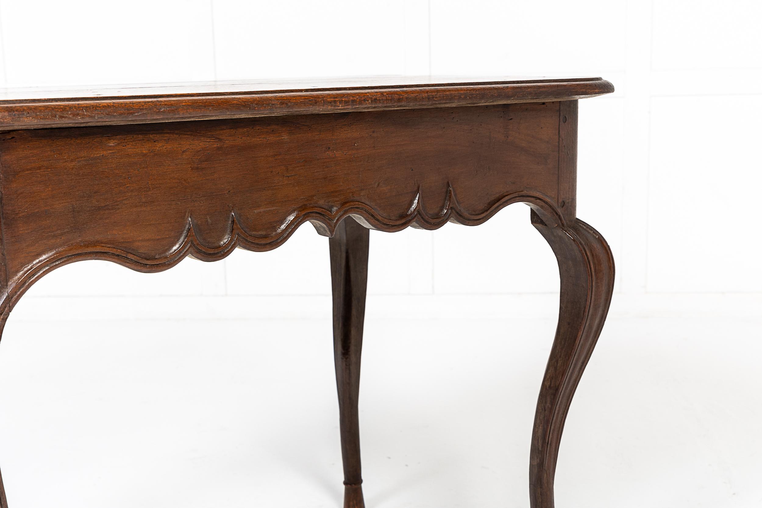A Fine Mid-18th Century French Louis XV Period Oak Side or Occasional Table with Panelled and Moulded Detailing.

This charming table dates to the middle of the 18th century and is of excellent colour. The three plank top features a simple edge