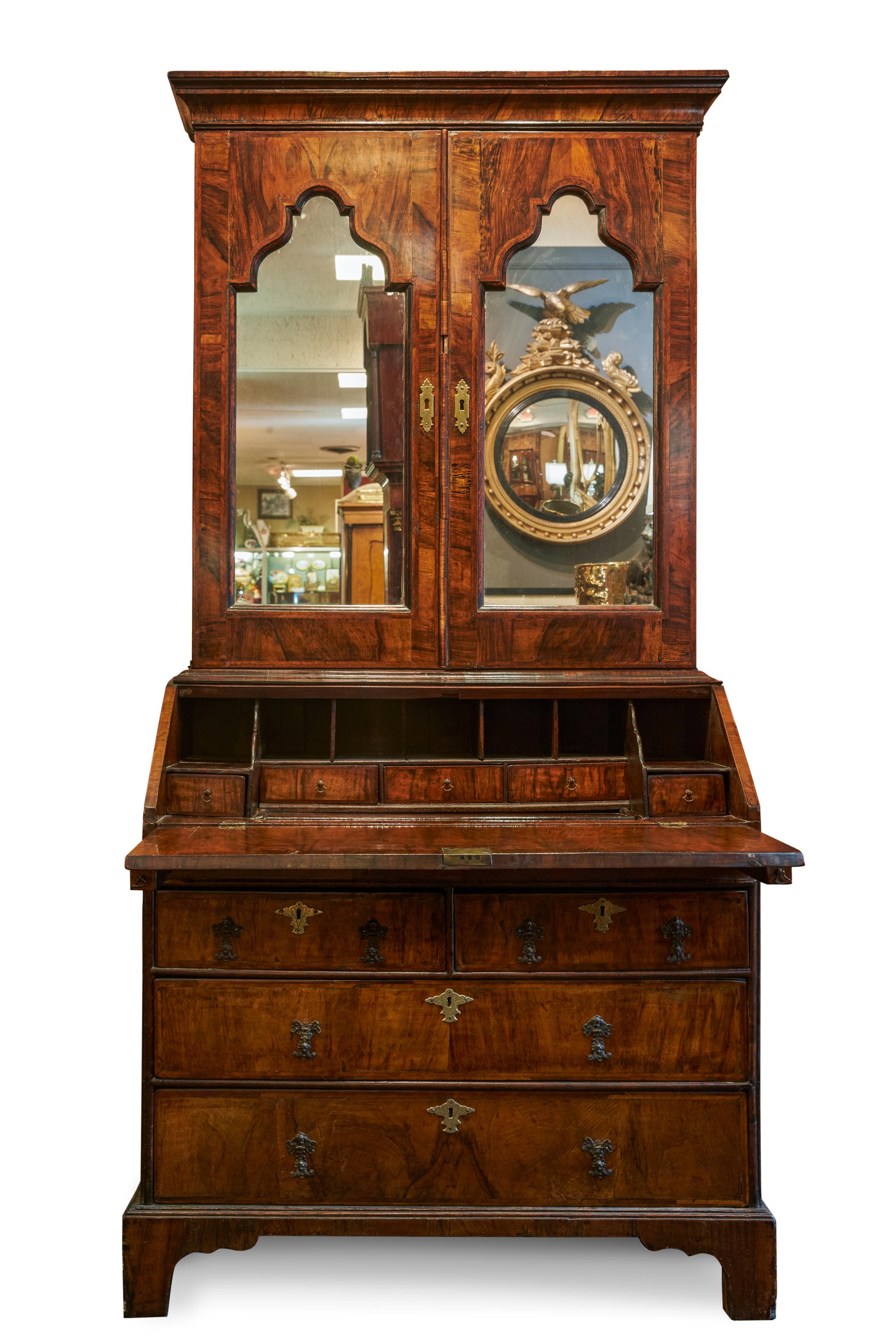 George II Inlaid walnut bureau bookcase
Mirrored uppercase with pigeonholes and shelves
Mid-18th Century
Measures: 77.5