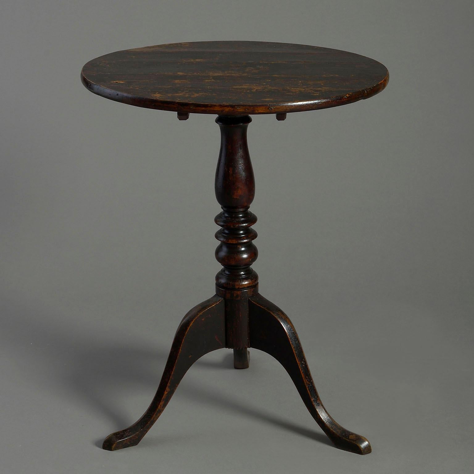 A mid-eighteenth century ebonised occasional tripod table, the circular top raised upon a turned stem and terminating in three cabriole legs.

Circa 1760 England

Dimensions: 23.25 W x 22.5 D x 29 H inches
59 W x 57 D x 73 H cm.