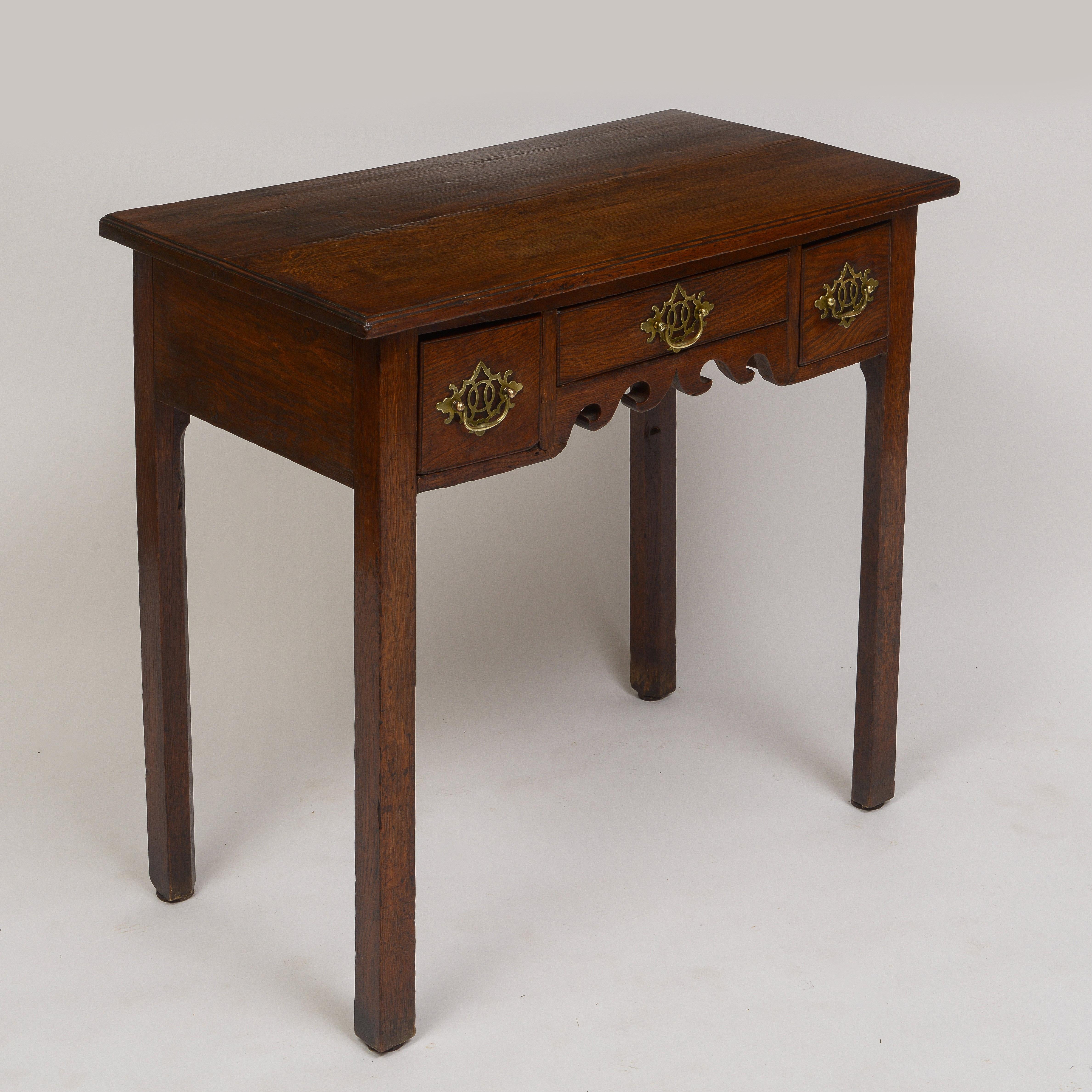 18th Century Georgian Oak Lowboy
Three drawers over decorative carving
Period brass George 2 hardware
Supported on Marlboro legs