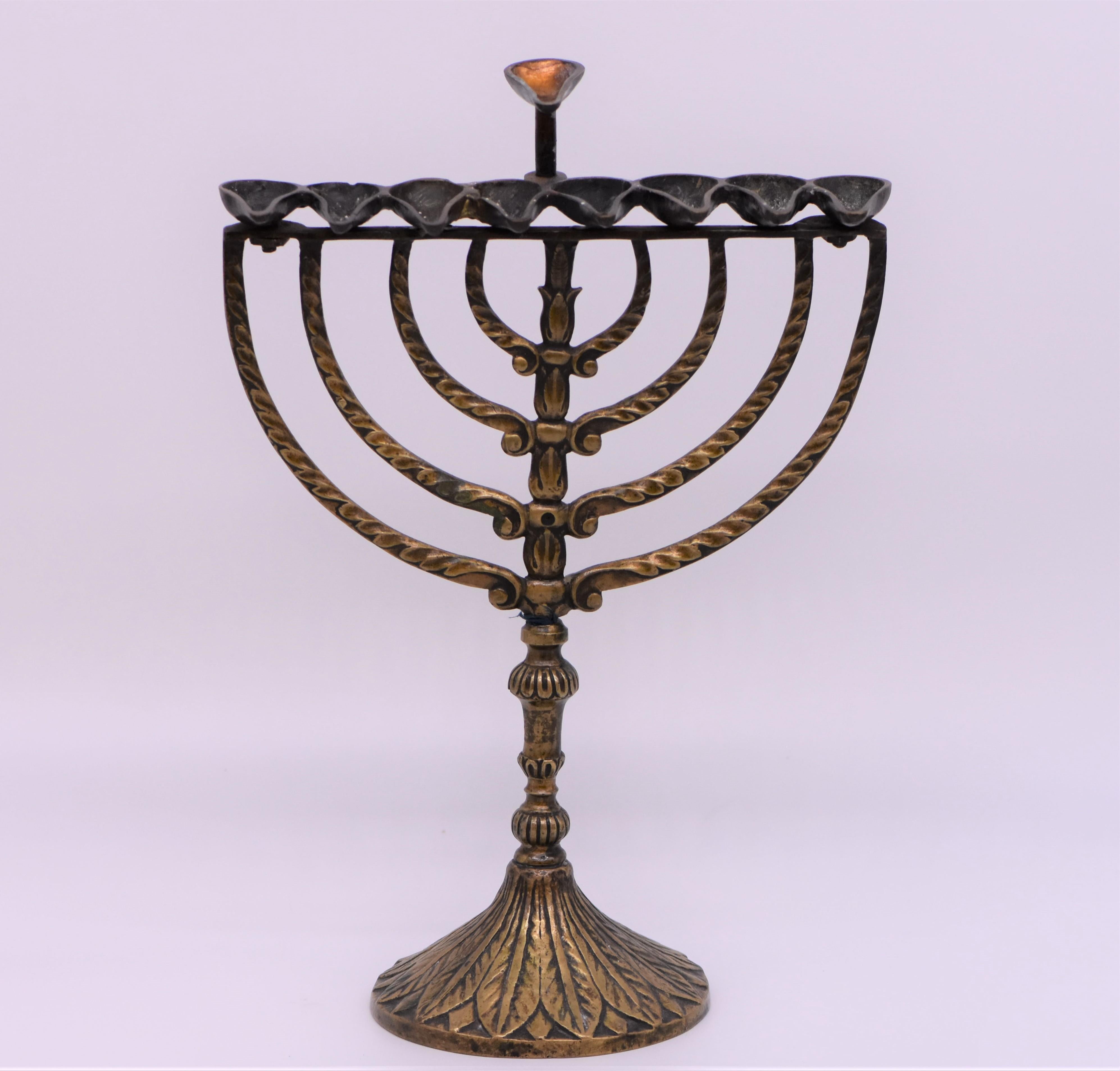 Rare bronze Hanukkah lamp Menorah, Italy, circa 1750. 
On round decorated base with baluster shape stem. 
The upper portion constructed with eight semicircle arms support eight oil fonts and one servant light.
This Hanukkah lamp is cast in the