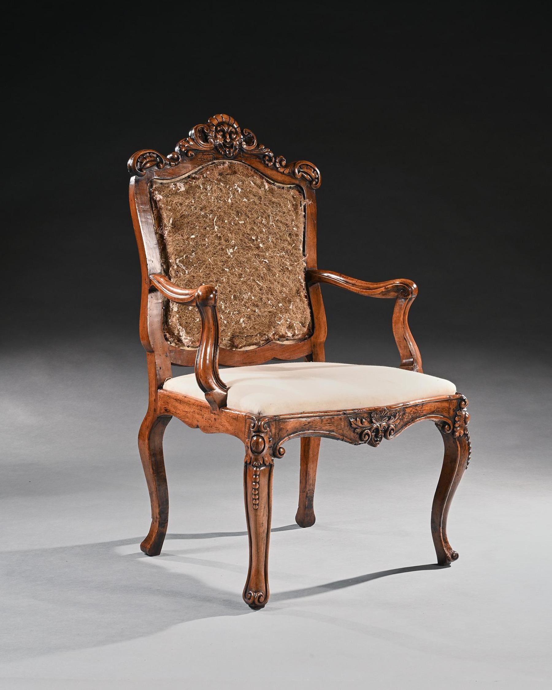 Mid 18th Century Italian Rococo Armchair in Walnut with Extravagantly Carved Head Rail

Italian Circa 1760

This beautiful armchair is executed in walnut and, in its basic form, is highly influenced by the French designs of the Louis XV period which