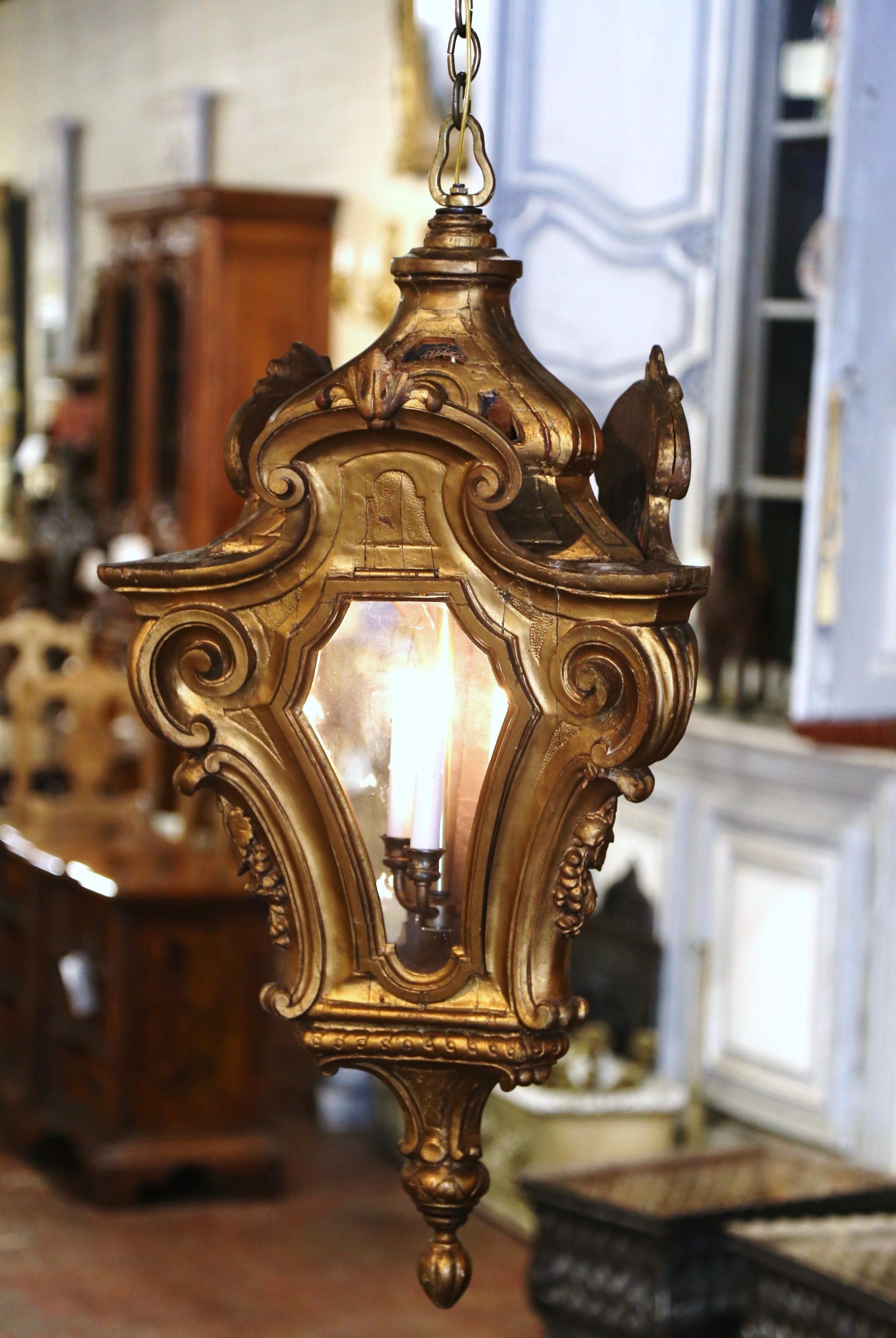 Bring Classic, Italian elegance into your home with this large Rococo hand carved hall lantern. Crafted in Italy, circa 1760, this traditional polygon light fixture is a true showstopper. The wooden lantern with dome top and scroll decor, has