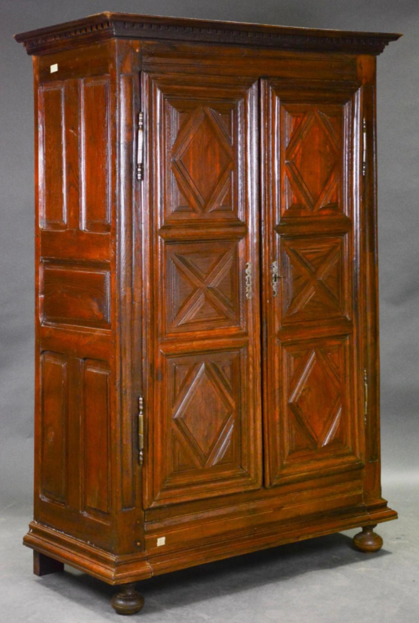 Beautiful French Louis XIII Period Carved Oak Double Door Robe with Raised Panels. Hand-carved details, original hinges with ogee based trim over raised bun feet. 
