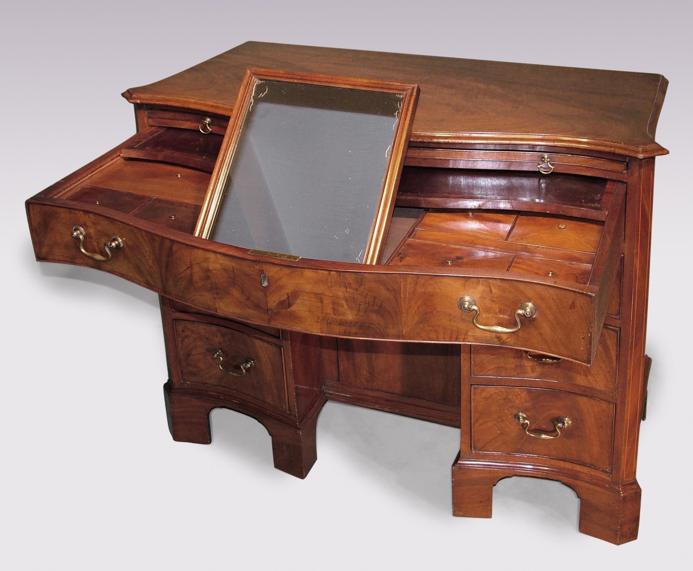 A fine 18th century mahogany kneehole dressing chest having moulded edge top above brushing slide, fitted top drawer, six short graduated cockbeaded drawers and cupboard in central recess, supported on bracket feet.