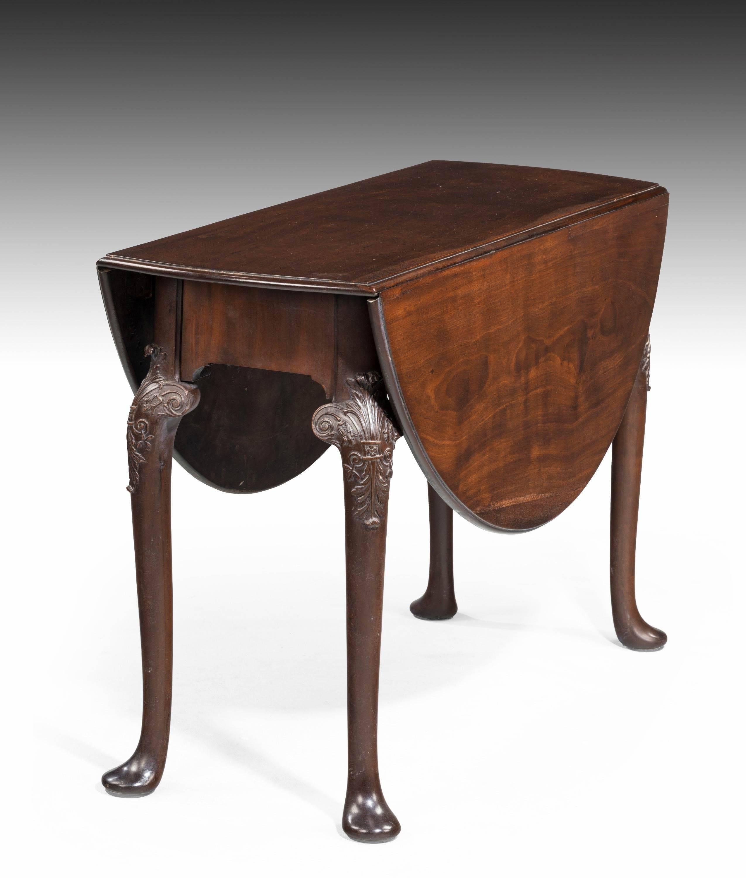 A very good mid-18th century mahogany oval drop leaf table. The knees beautifully carved over gentle cabriole supports ending in pad feet. Excellent original overall condition. Possibly Irish. 

Measures: When open 48.25 x 40.25 inches.