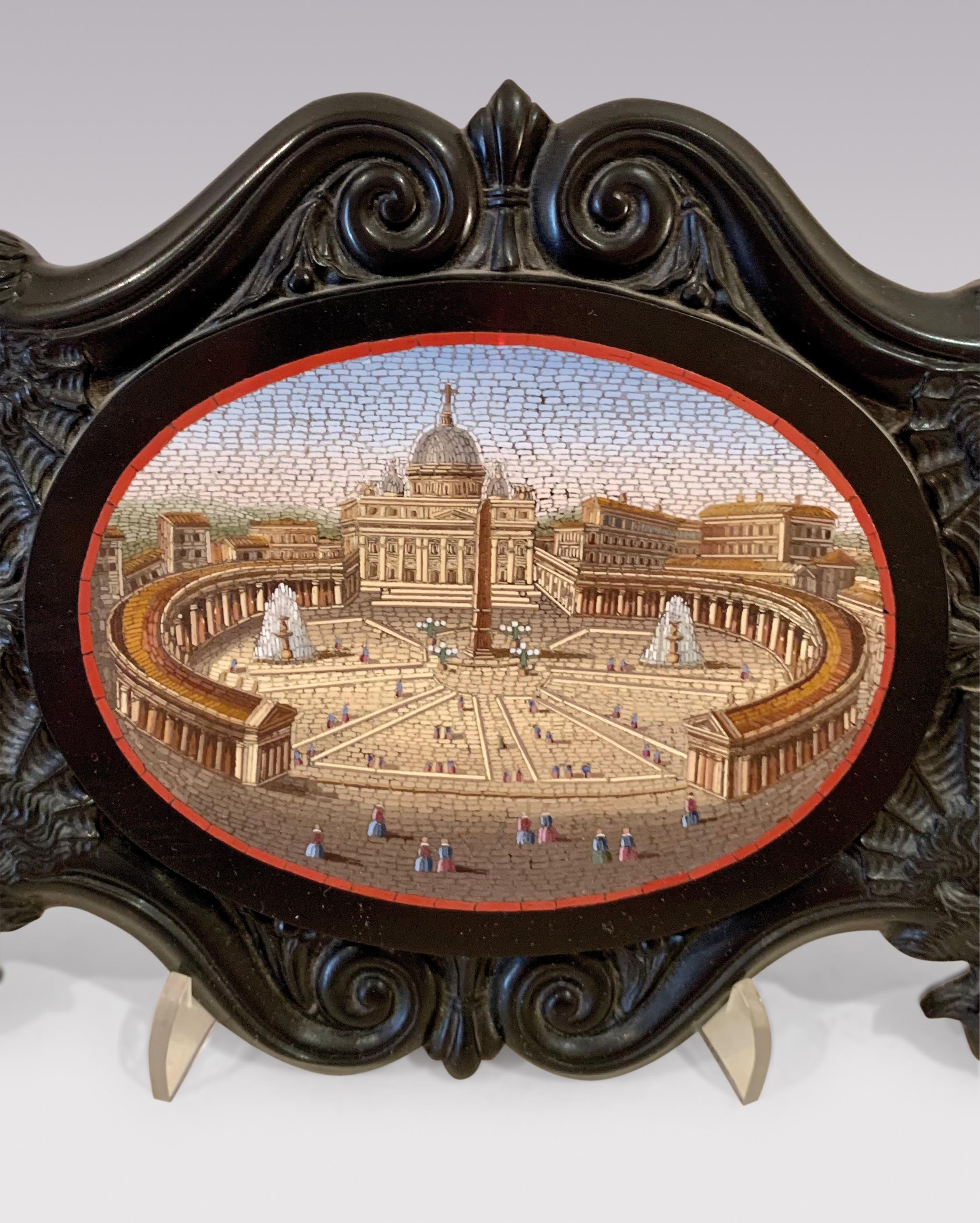 A fine quality mid 19th century oval Micro-mosaic Plaque depicting St Peter’s Square Rome, enclosed in unusual black slate marble frame decorated with shells, scrolls & wolves.