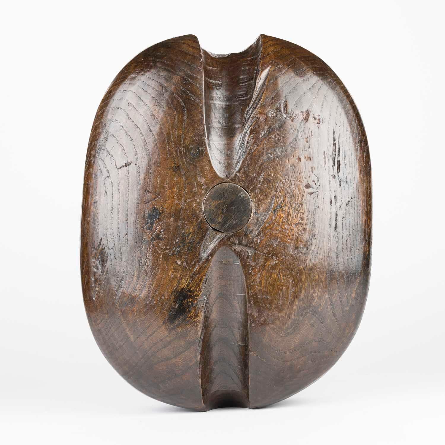 A mid 18th century Naval ship’s elm single pulley block, made in three parts – pulley, pin and shell.

Height:  38 cm.

Width:  30 cm.

Depth:  15 cm.
 

In sailing, a block is a single or multiple pulley. One or a number of sheaves are enclosed in