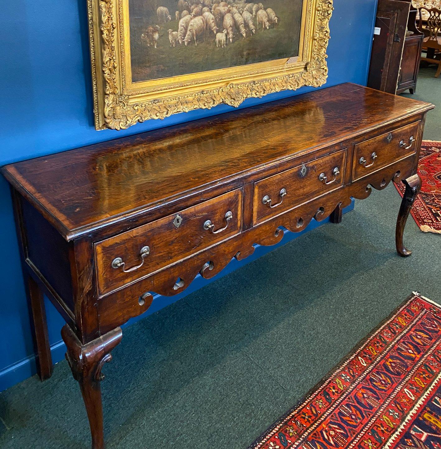 Mid-18th Century Oak George II English Sideboard with Brass Hardware.
Made of richly patinated oak having three drawers with 