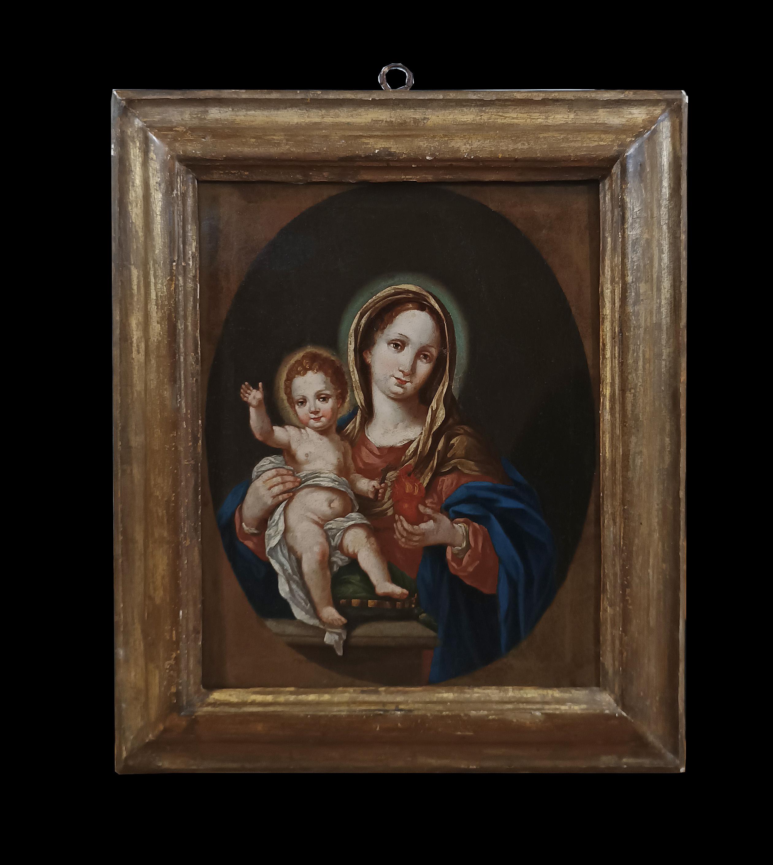 Beautiful oil painting on canvas, made on the first canvas and framed with a contemporary rectangular frame in carved and gilded wood. The painting represents a striking image of the Madonna with the baby Jesus inside an oval. The Madonna, with her