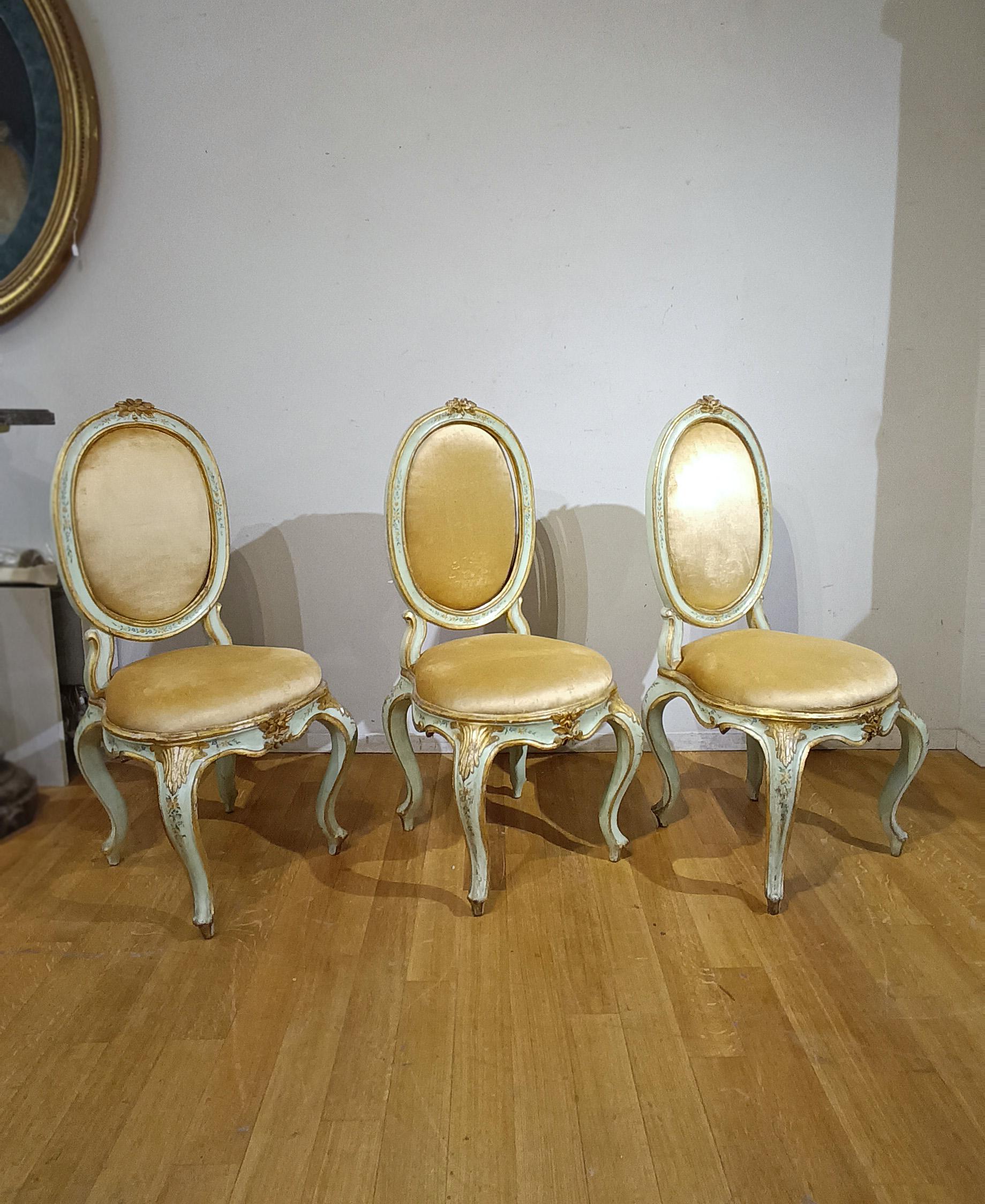 Elegant set of six chairs in solid carved, lacquered, painted and gilded wood. Their charm is enhanced by the pastel blue lacquer finish, which harmonizes with the padding of the backrest and seat, both gilded. An element of further refinement are