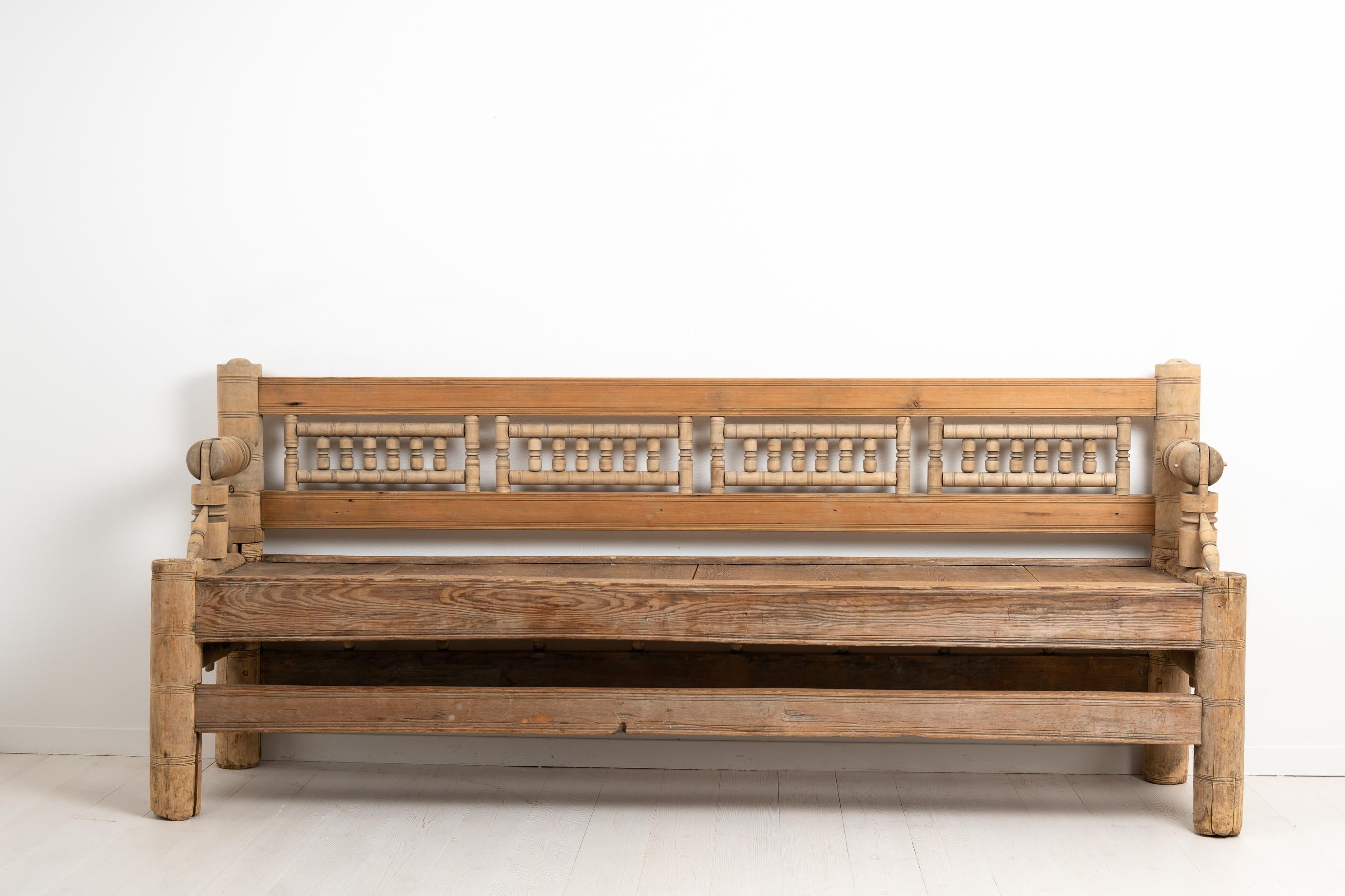 Early Swedish pine bench from northern Sweden. The bench is a very early version of a seat or sofa and this one also has a reversible backrest. It’s an unusual piece due to its age and construction. A bench such as this was commonly placed by a long