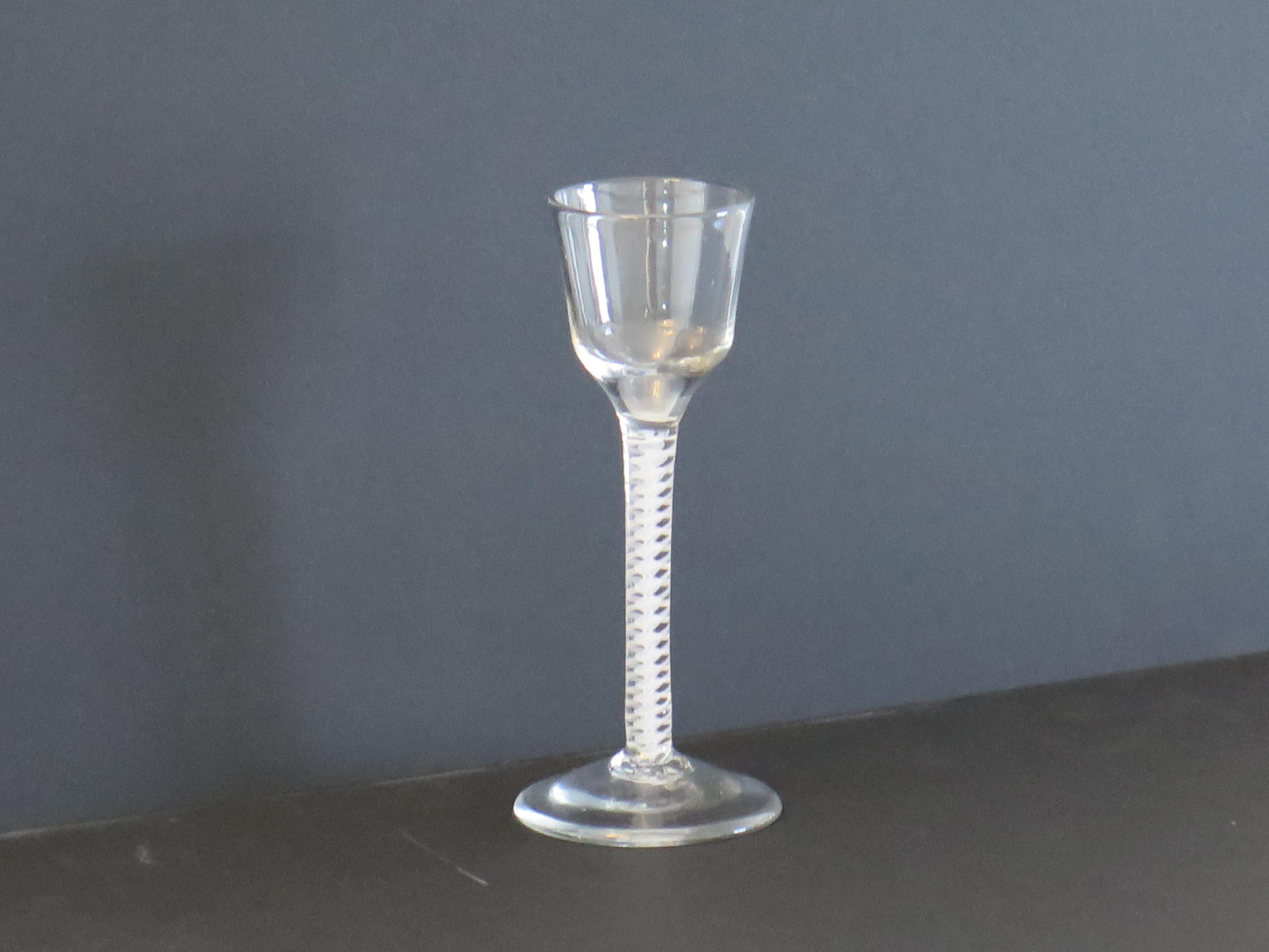 This is a good hand blown, English, mid-Georgian, Cordial drinking glass with a double series opaque twist (DSOT) stem, dating from the middle of the 18th century, circa 1765.

These handblown Georgian wine glasses are very collectable,  made from