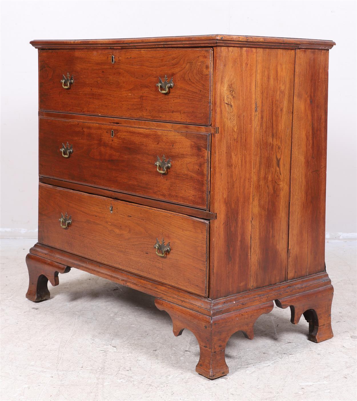 A charming colonial Southern chest in walnut. The surfaces of the chest are wonderfully worn and patinated. The theatrical feet are also original to the piece and are of uncommon form as is the arrangement of three graduated drawers. Virginia circa