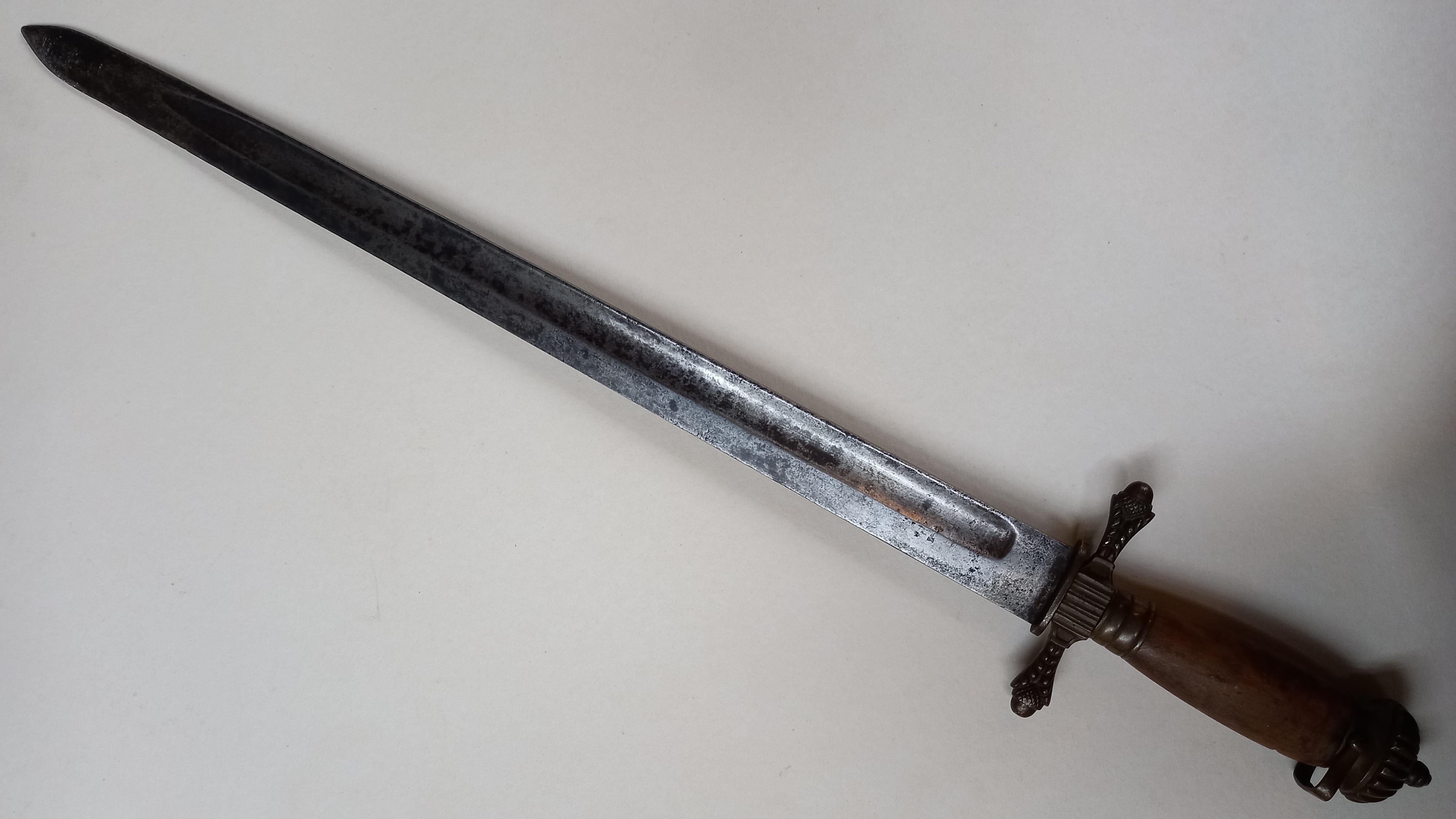 Mid 18th.century hunting sword or possibly pillow sword in very good uncleaned condition. All brass hilt fittings, missing grip wire, unmistakingly Scottish origin as suggested by the matching thistle quilllions and the large pommel cap seen