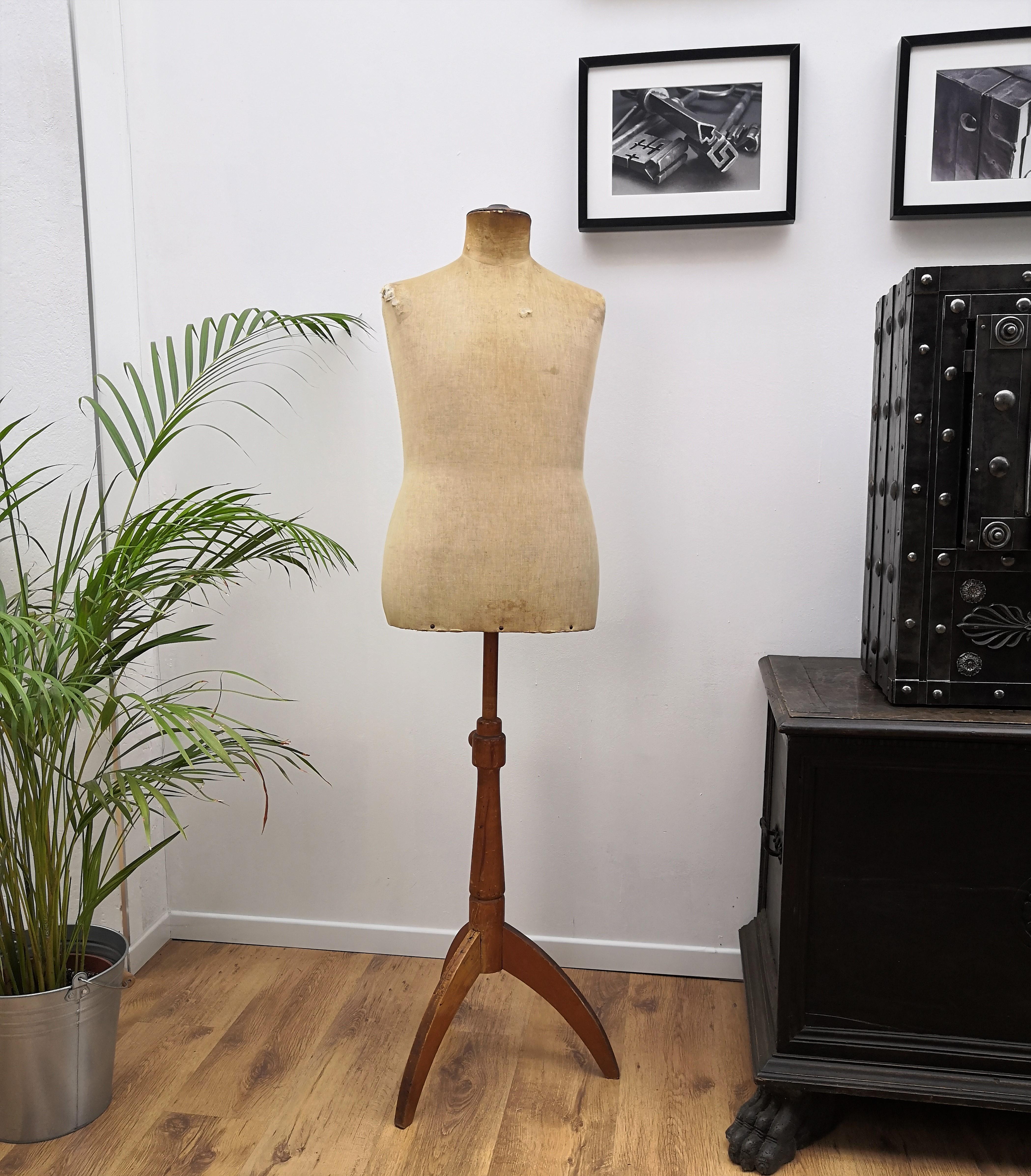 This Mannequin or dressmaker and tailor's dummy, stands on a tripod base in light oak wood and has leather detail in the neck/head. The dressmaker bust dates from around mid-1900, is in original conditions with great patina and feeling of past
