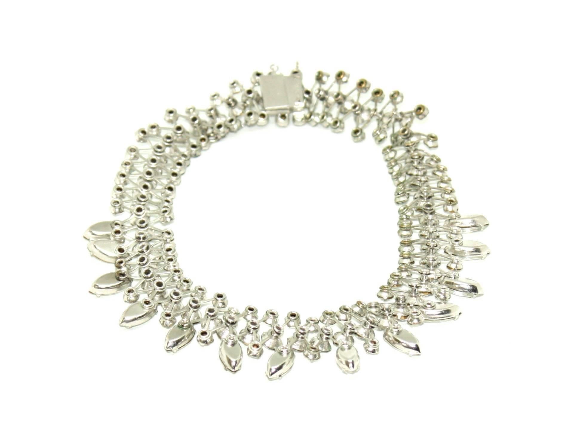 Absolutely stunning necklace featuring a variety of claw-set clear crystals on silver tone metal by Eisenberg. The box tongue clasp has the name Eisenberg written in script on the reverse and this mark can be dated to around the mid 1940's. The