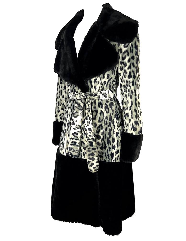 Presenting a beautiful black and white cheetah print faux fur Dolce and Gabbana coat. From the mid 1990s, this coat is constructed of a faux fur black leopard print with black foam fur finishes at the lapel, cuffs, and hem of the coat. Not for the