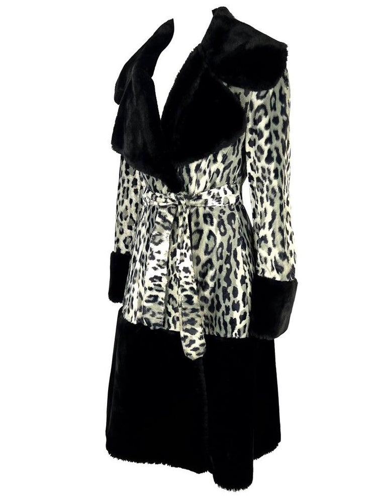 TheRealList presents: a beautiful black and white cheetah print faux fur Dolce and Gabbana coat. From the mid 1990s, this coat is constructed of a faux fur black leopard print with black foam fur finishes at the lapel, cuffs, and hem of the coat.