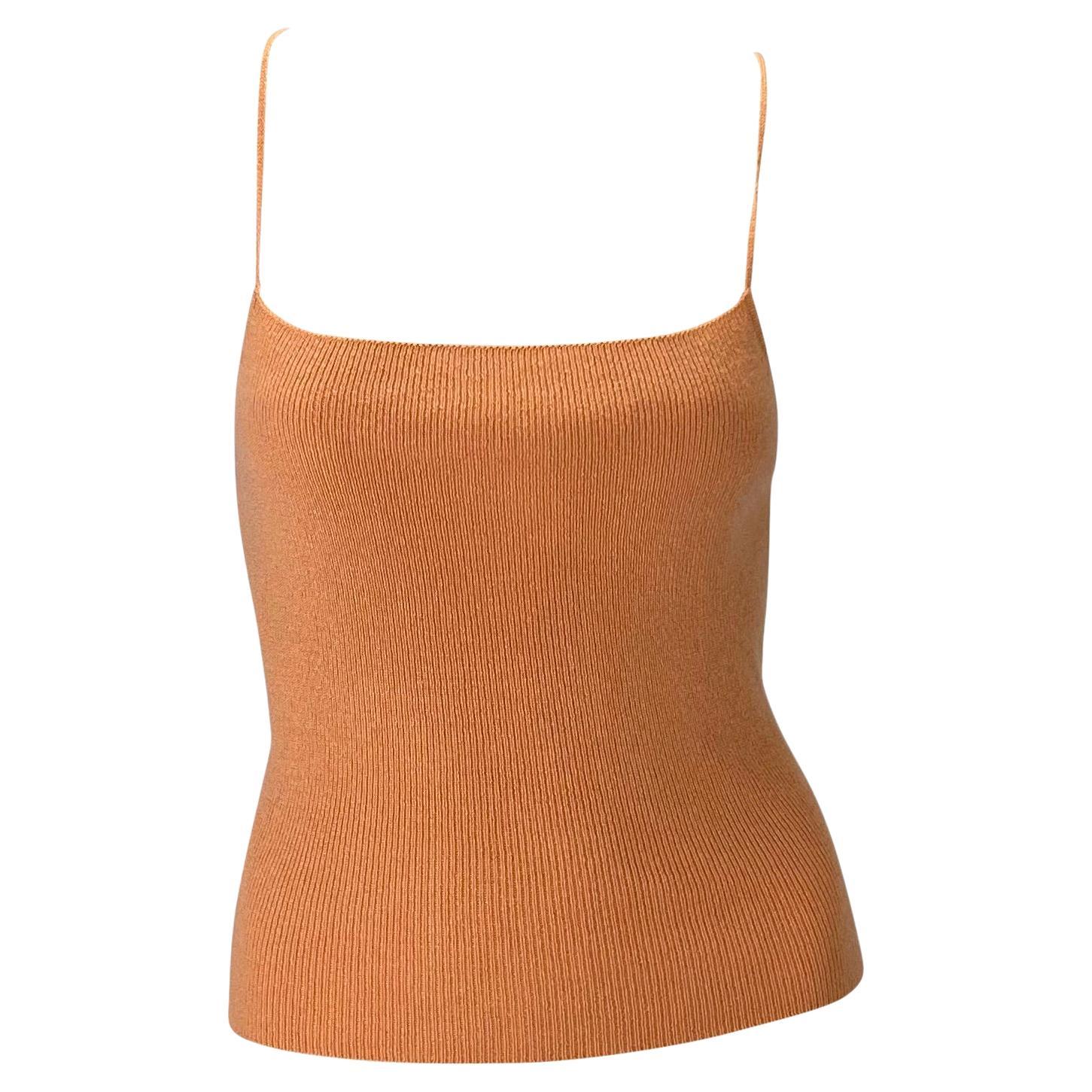 Presenting a peach-colored knit lace-up Gucci sweater top, designed by Tom Ford. From the mid-1990s, this knit tank top features a square neckline, spaghetti straps, and a lace-up back. An unusual piece of Gucci, this stretchy top has the perfect