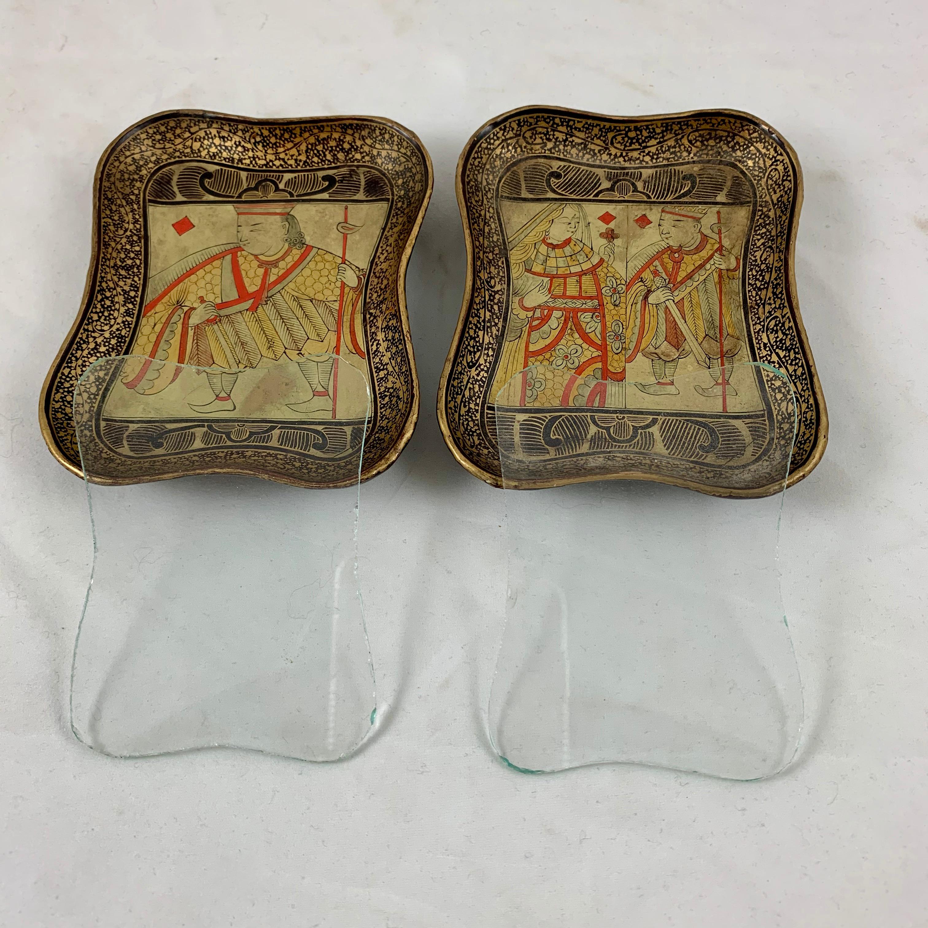 A set of two English lacquer papier mâché card counter trays with the original shaped glass liners, circa 1850–1860, mid-19th century.

Vide-poche counter trays, were especially made to be used in card games for holding chips or bone counters when