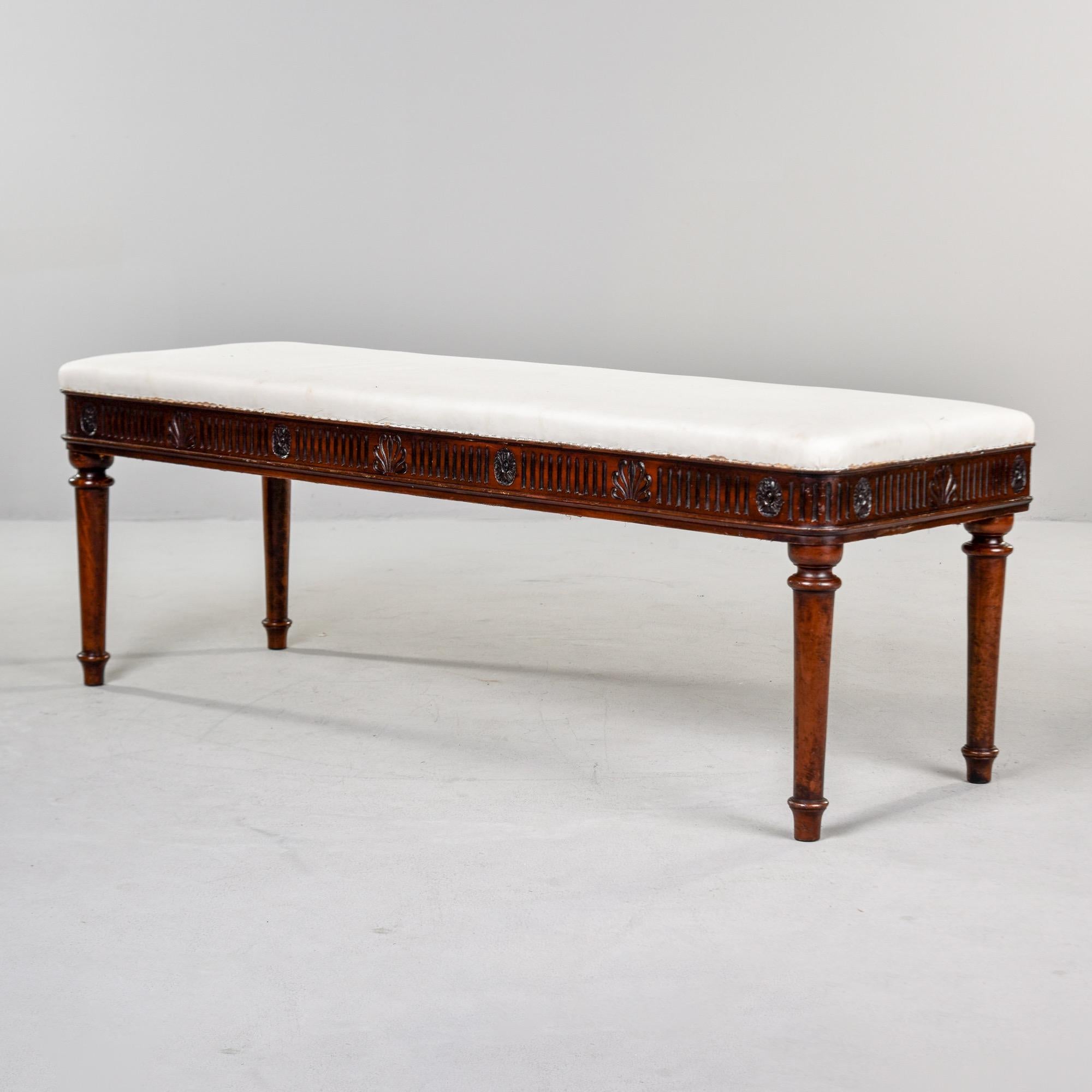 Found in England, this Regency style window seat or bench dates from the mid 1800s. Bench is mahogany with turned legs and decorative carved details including fans, rosettes and reeding. Stain on the frame was deepened by a professional in England.