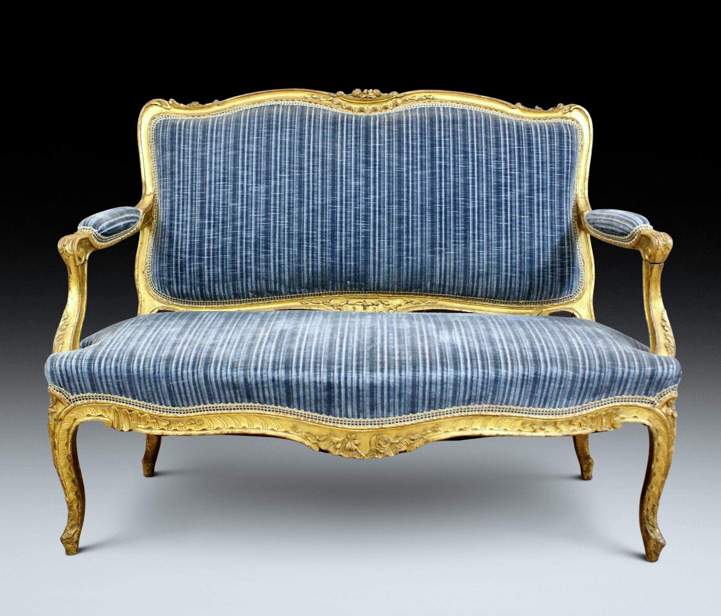 This gorgeous and suburb quality mid-19th century French settee features the original gilding on the wood and nicely detailed carving thru out. The settee is supported on cabriole legs with a shaped front skirt and padded arm rests. The brilliant