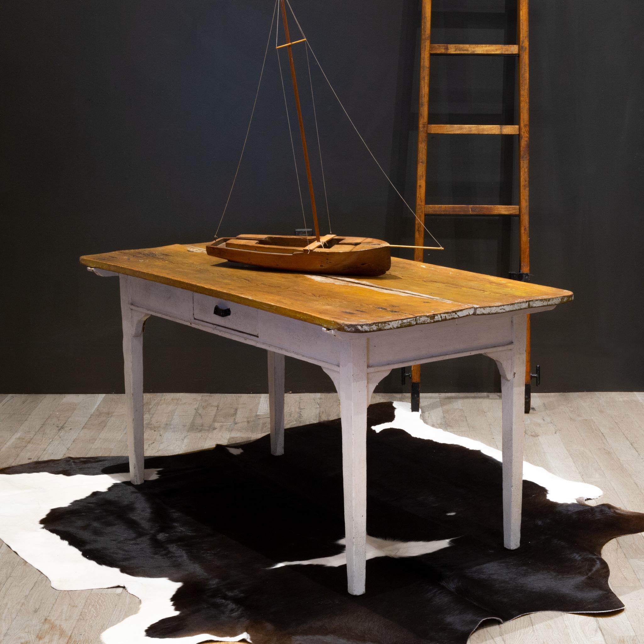 ABOUT

A handmade mid-19th century Mennonite farmhouse table table with center drawer. The top consists of two wide planks which is an indication of age. Harvested trees where much larger during this period. Antique nail heads are clearly visible