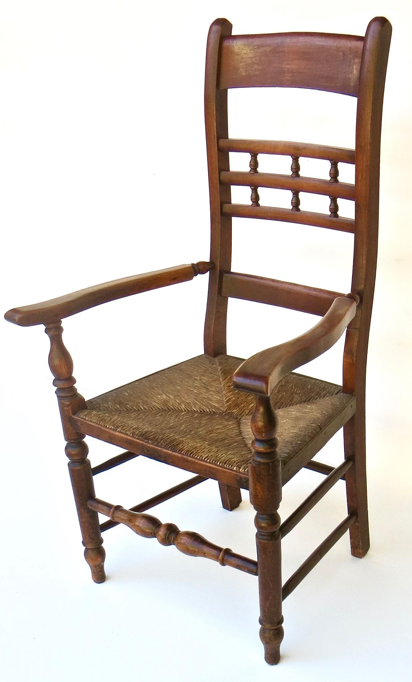 Very nicely appointed Victorian rush seated ladder back chair; English and mid 19th century. A little different with the fret back design, this chair is in completely all original condition and surface, with the original rush seat in sound and